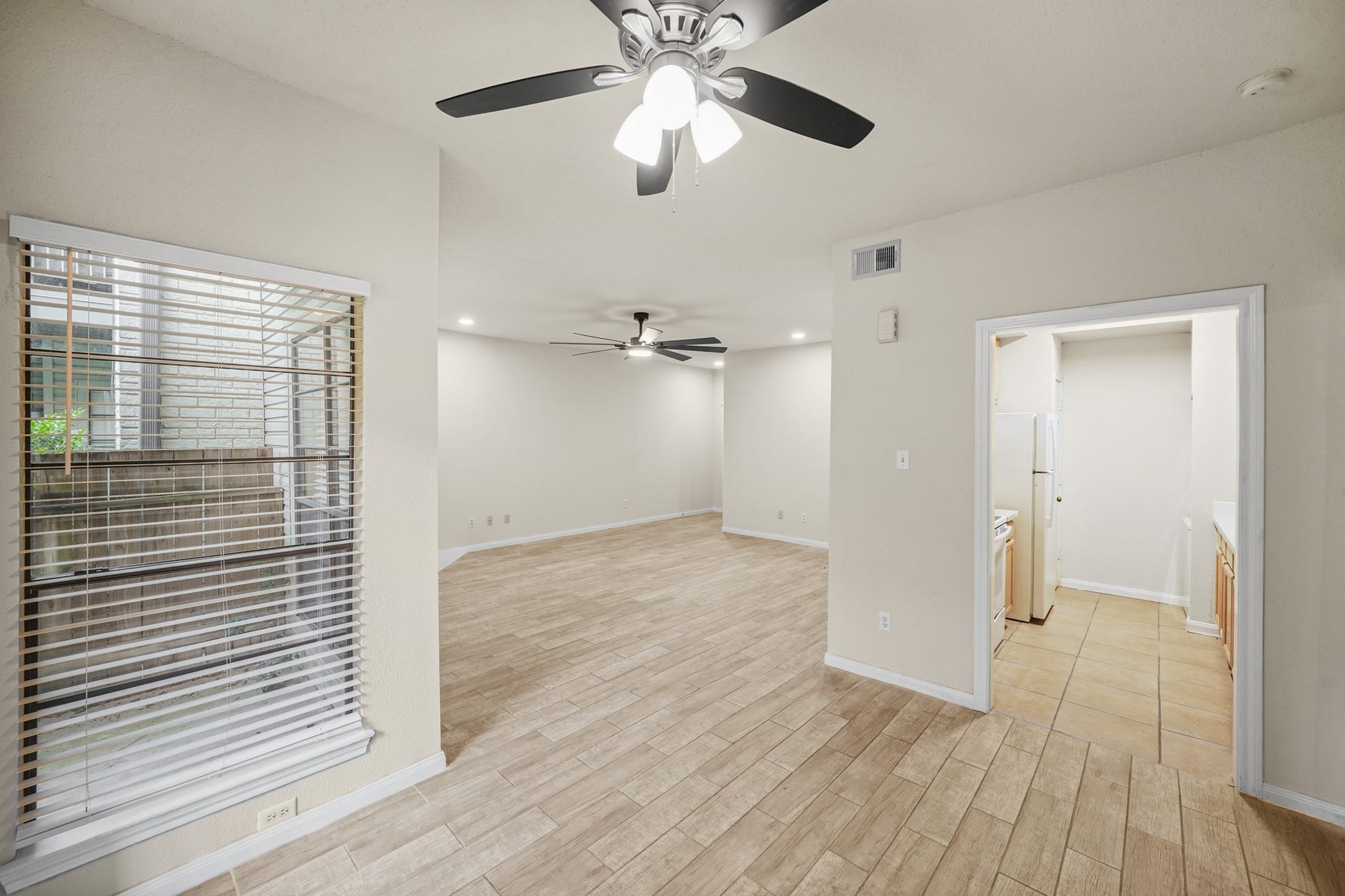 View of the living area and entrance way to the kitchen from the dining area.