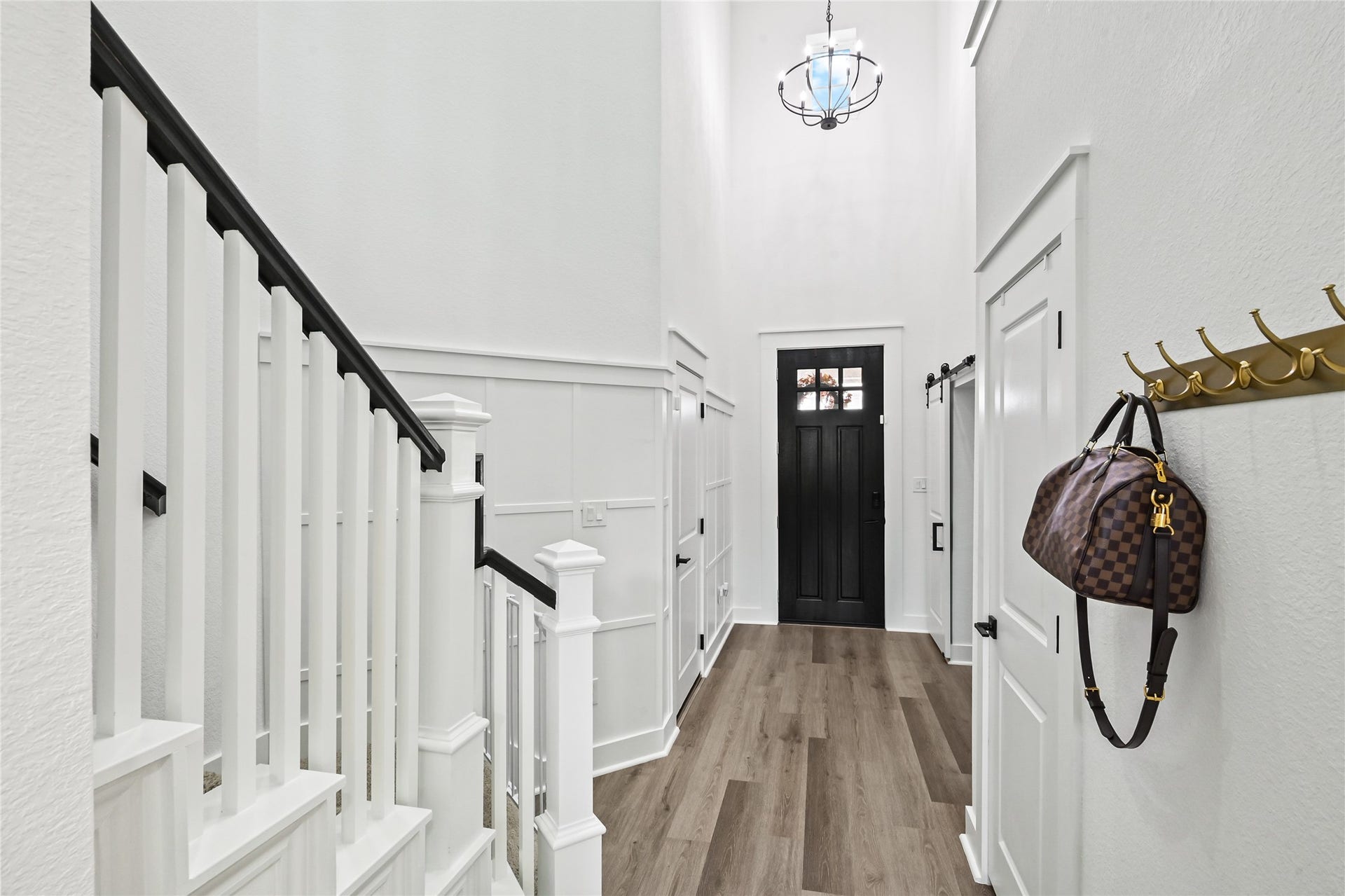 4121 Hazy Rock Lane, League City, TX 77573 Bright foyer features soaring ceilings, crisp white walls, decorative wainscoting