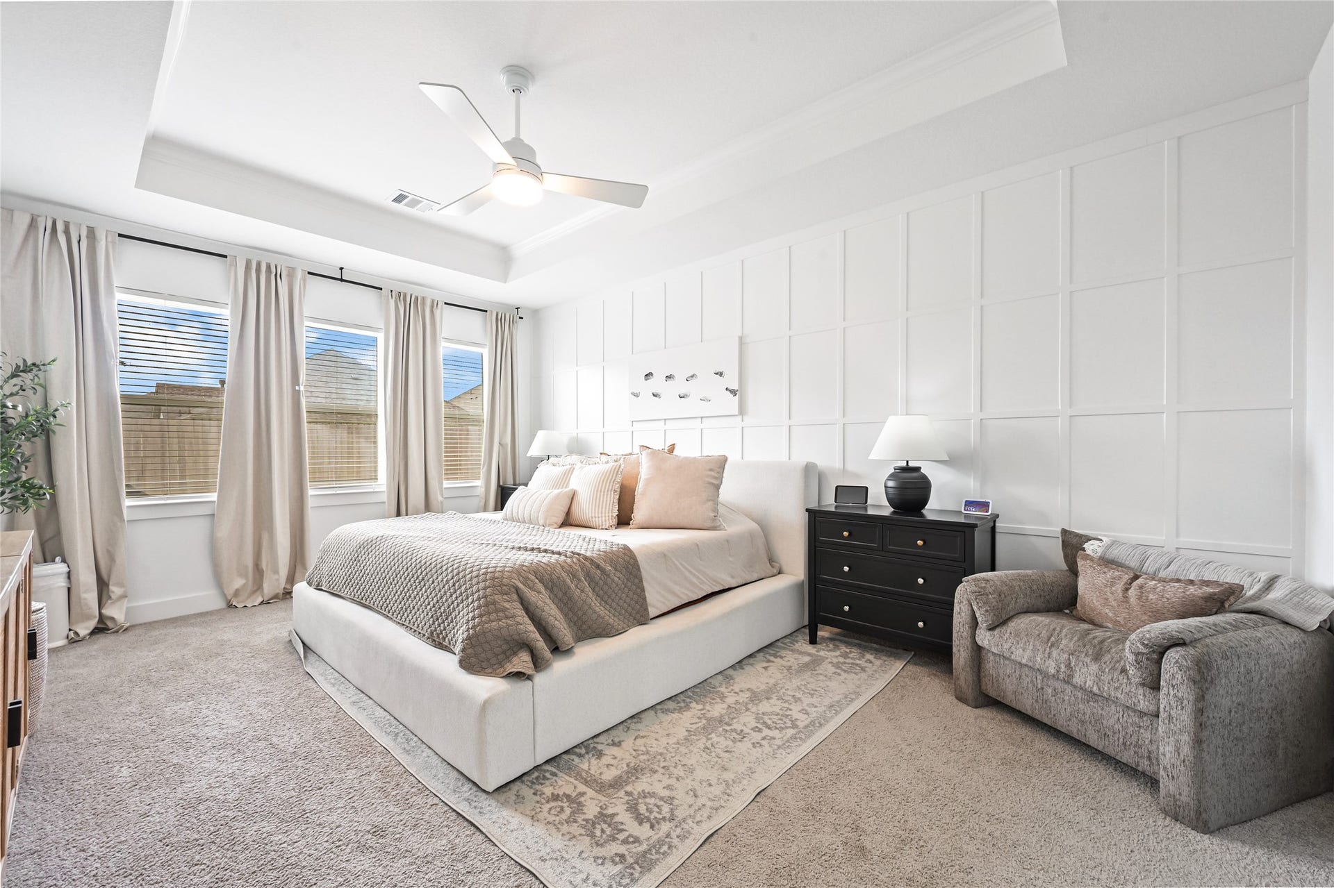 4121 Hazy Rock Lane, League City, TX 77573 stunning primary bedroom suite, A beautiful tray ceiling with crown molding adds, floor-to-ceiling board-and-batten accent wall, Large windows
