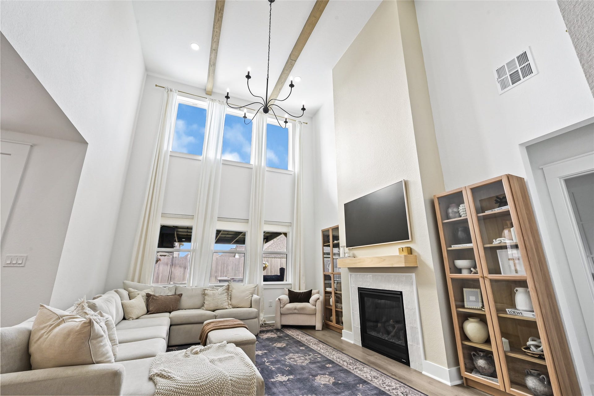 4121 Hazy Rock Lane, League City, TX 77573 Soaring ceilings, expansive windows, and an abundance of natural light