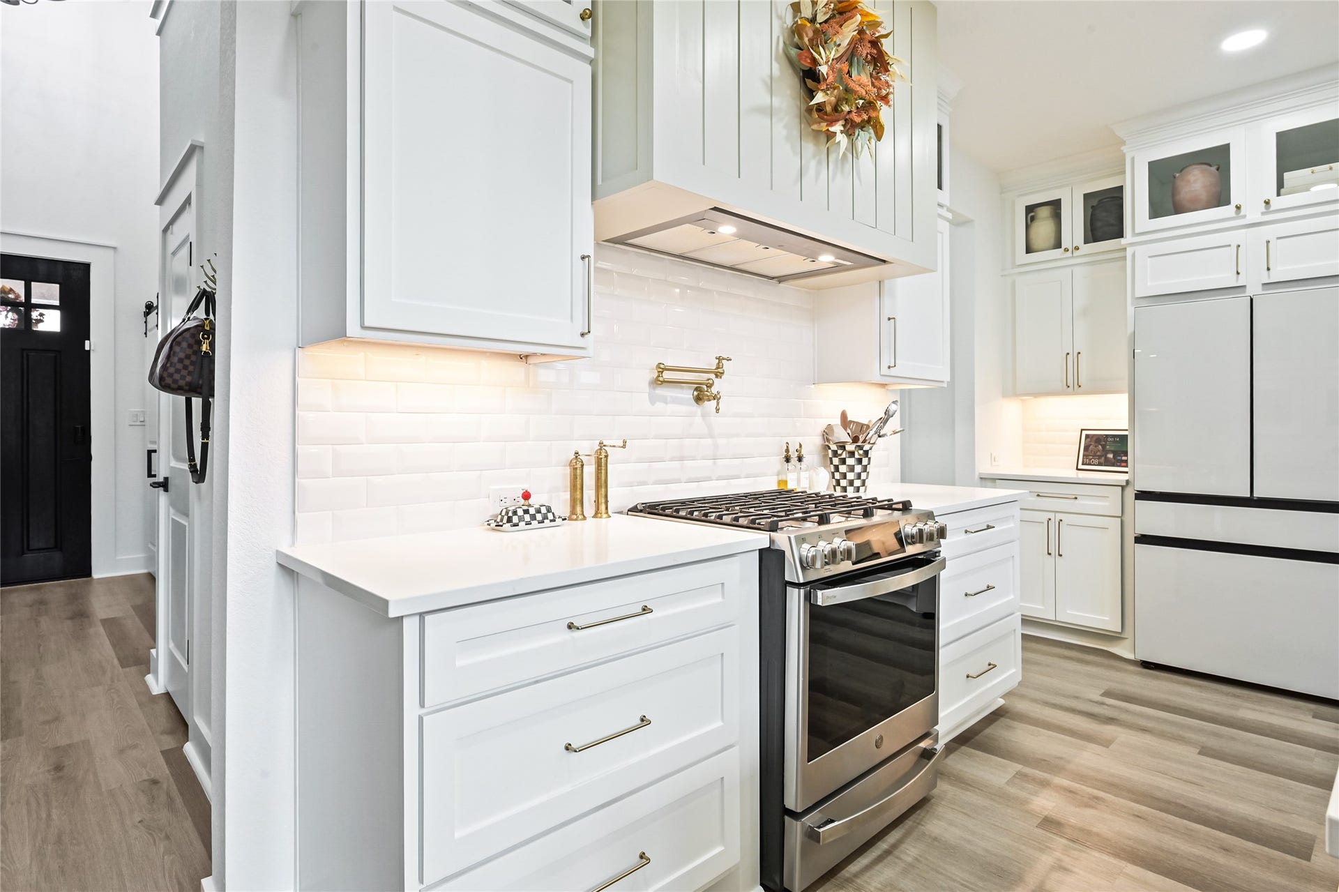 4121 Hazy Rock Lane, League City, TX 77573 Sleek stainless steel gas range with a coordinating vent hood