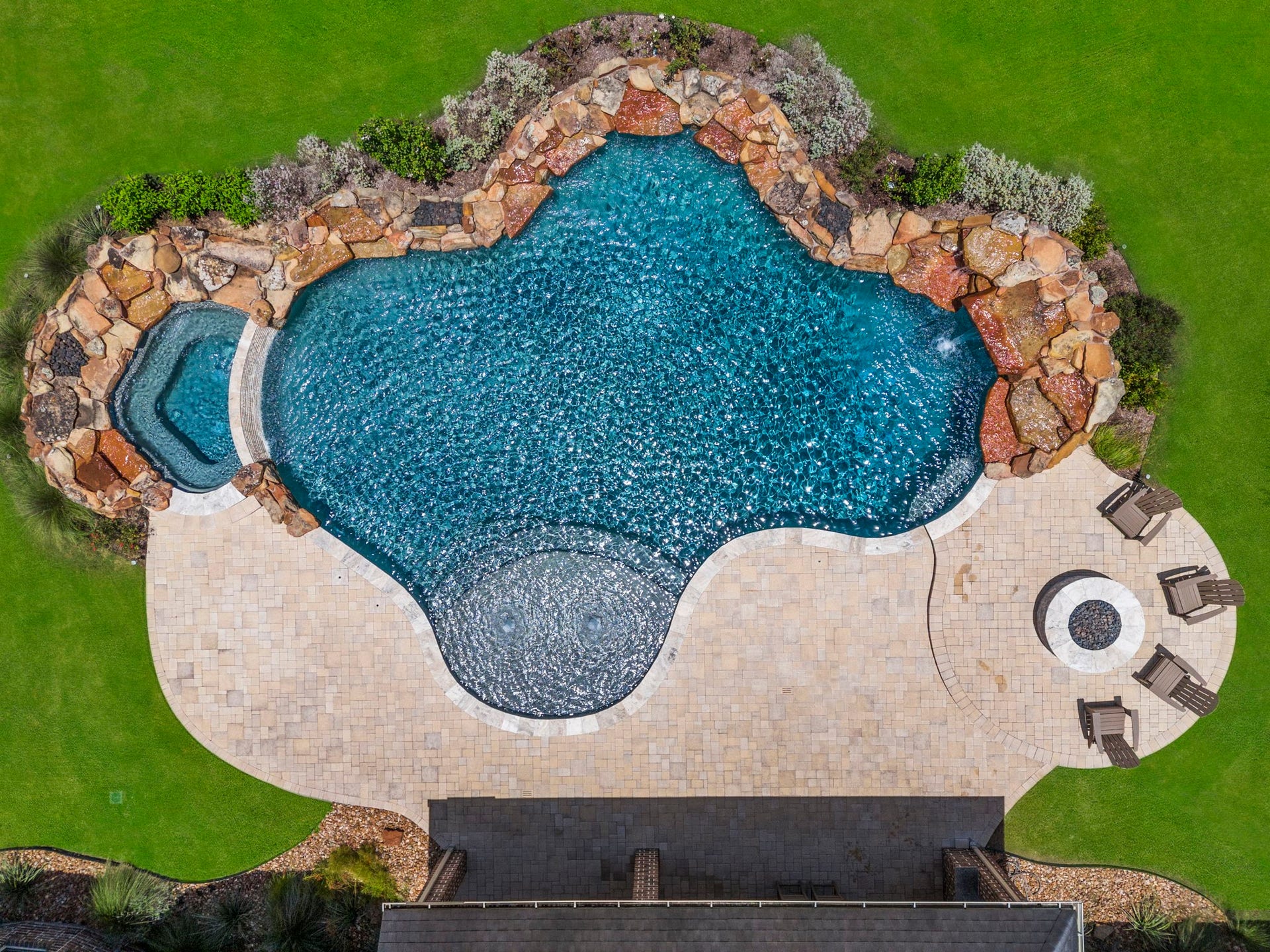 29826 Deer Crest Lane, Fulshear, TX 77406 An impressive aerial view showcases the scale of the backyard with expansive paver decking, multiple gathering areas & generous green space. A dedicated fire pit creates the perfect setting for evenings outdoors.