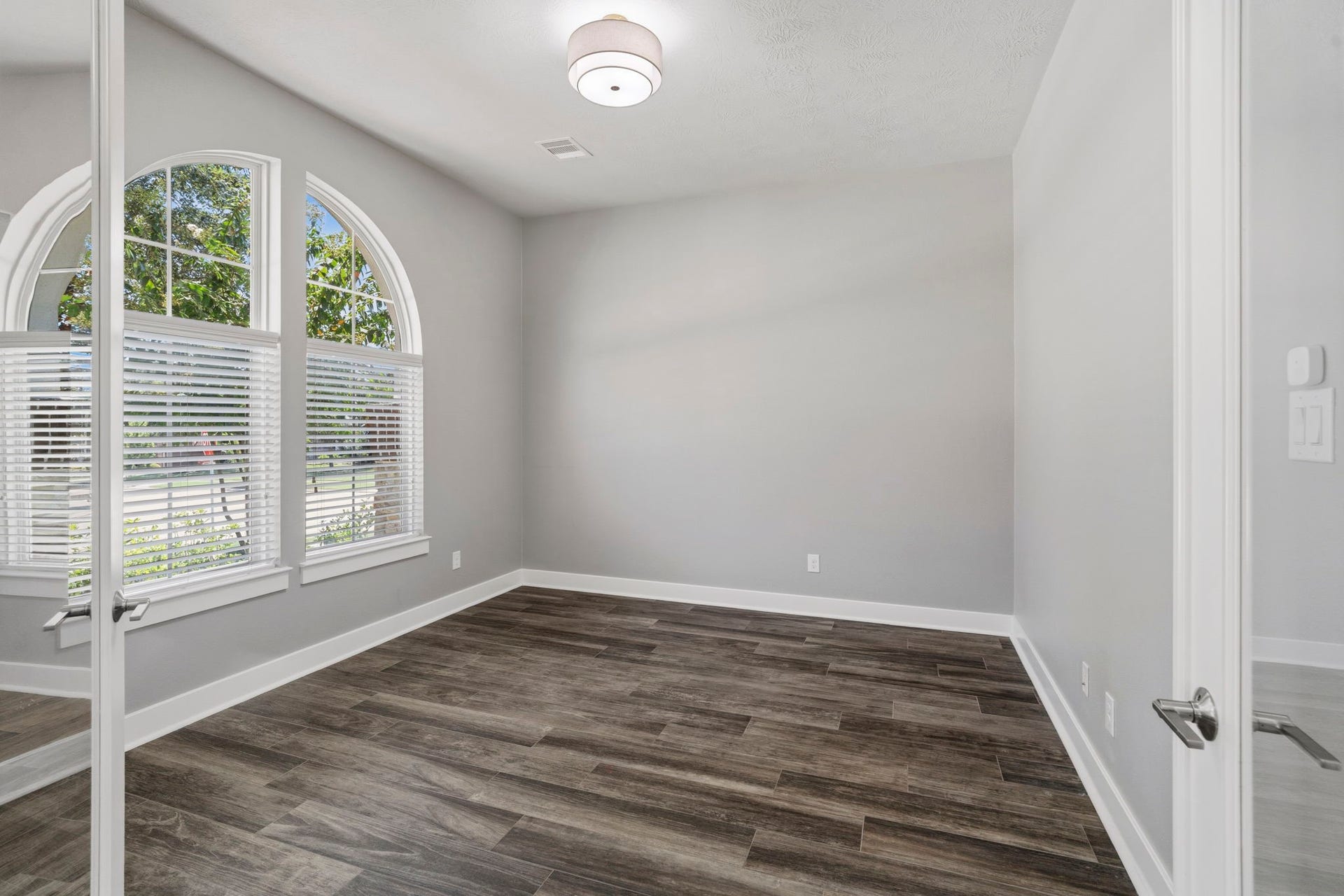 29826 Deer Crest Lane, Fulshear, TX 77406 Double glass doors create an impressive entrance to the private executive study, allowing natural light to flow through while maintaining a defined workspace.