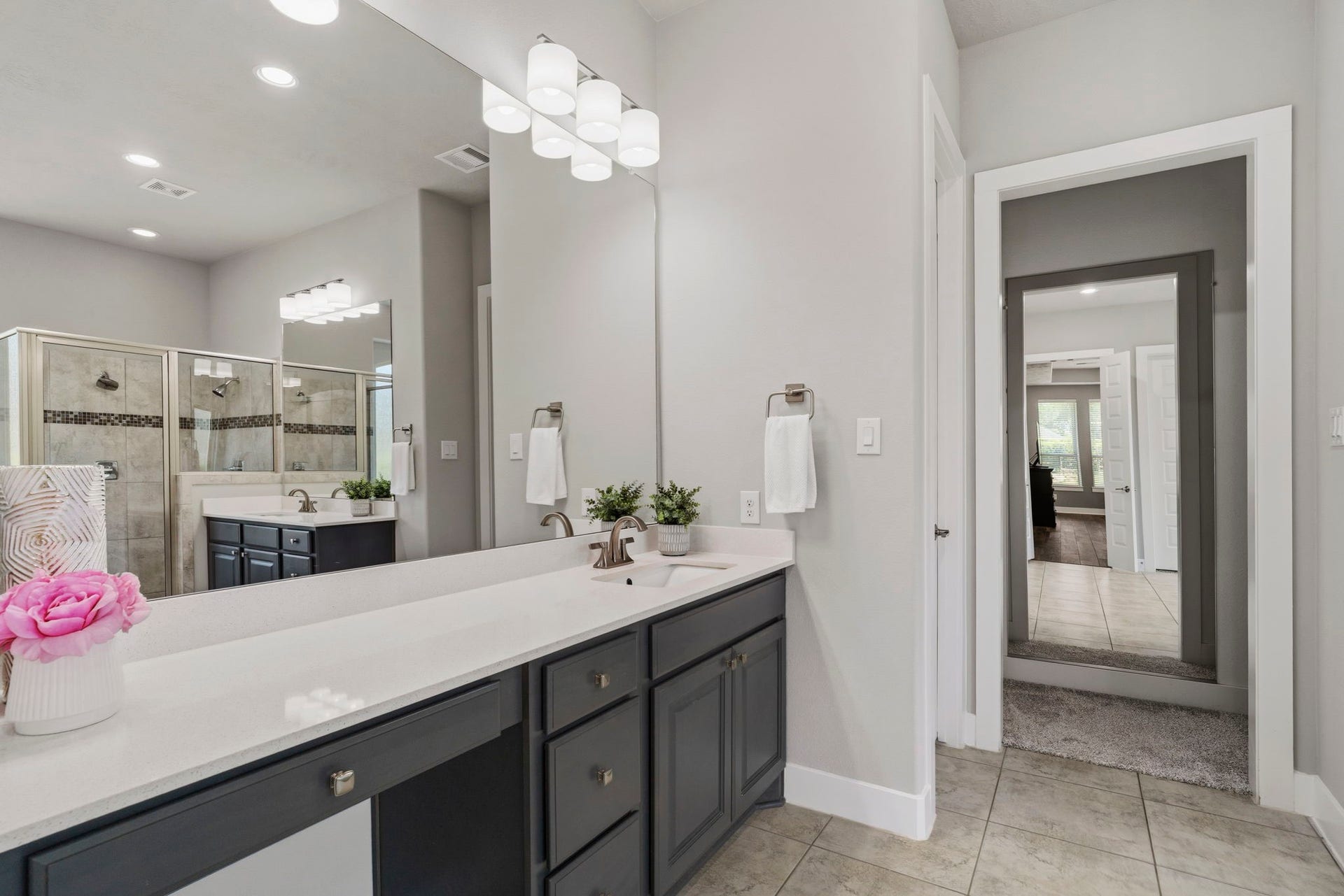 29826 Deer Crest Lane, Fulshear, TX 77406 The spacious primary bath features an extended dual-sink vanity with abundant storage, complemented by a separate walk-in shower & oversized closet beyond.