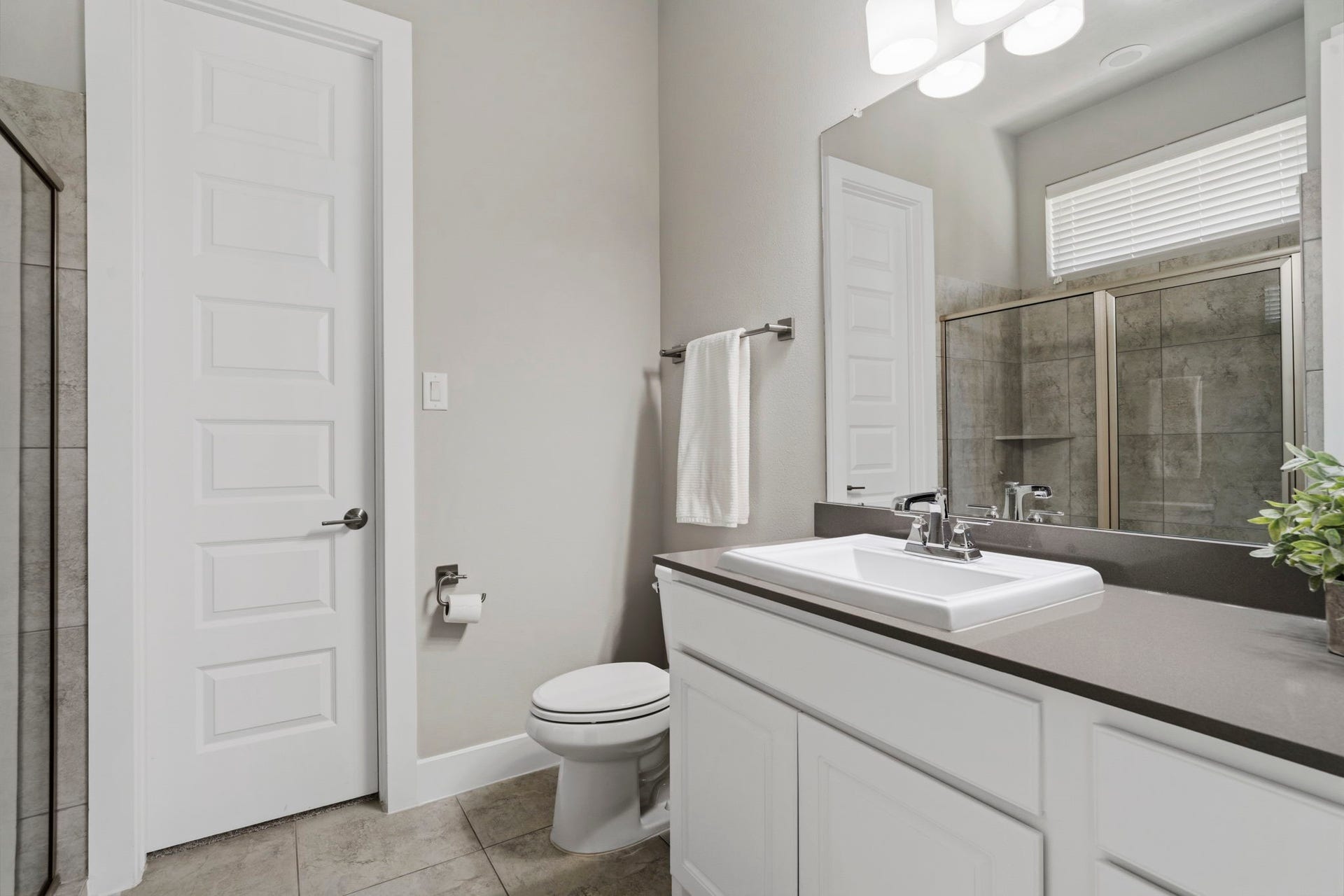 29826 Deer Crest Lane, Fulshear, TX 77406 The private en-suite bath serving the downstairs secondary bedroom features a spacious vanity.