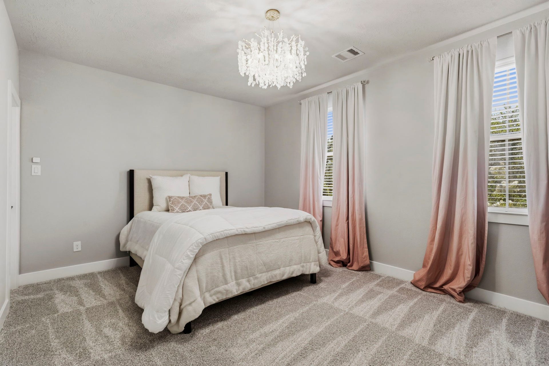 29826 Deer Crest Lane, Fulshear, TX 77406 A spacious secondary bedroom is filled with natural light & features new carpet, neutral finishes & an updated designer light fixture.