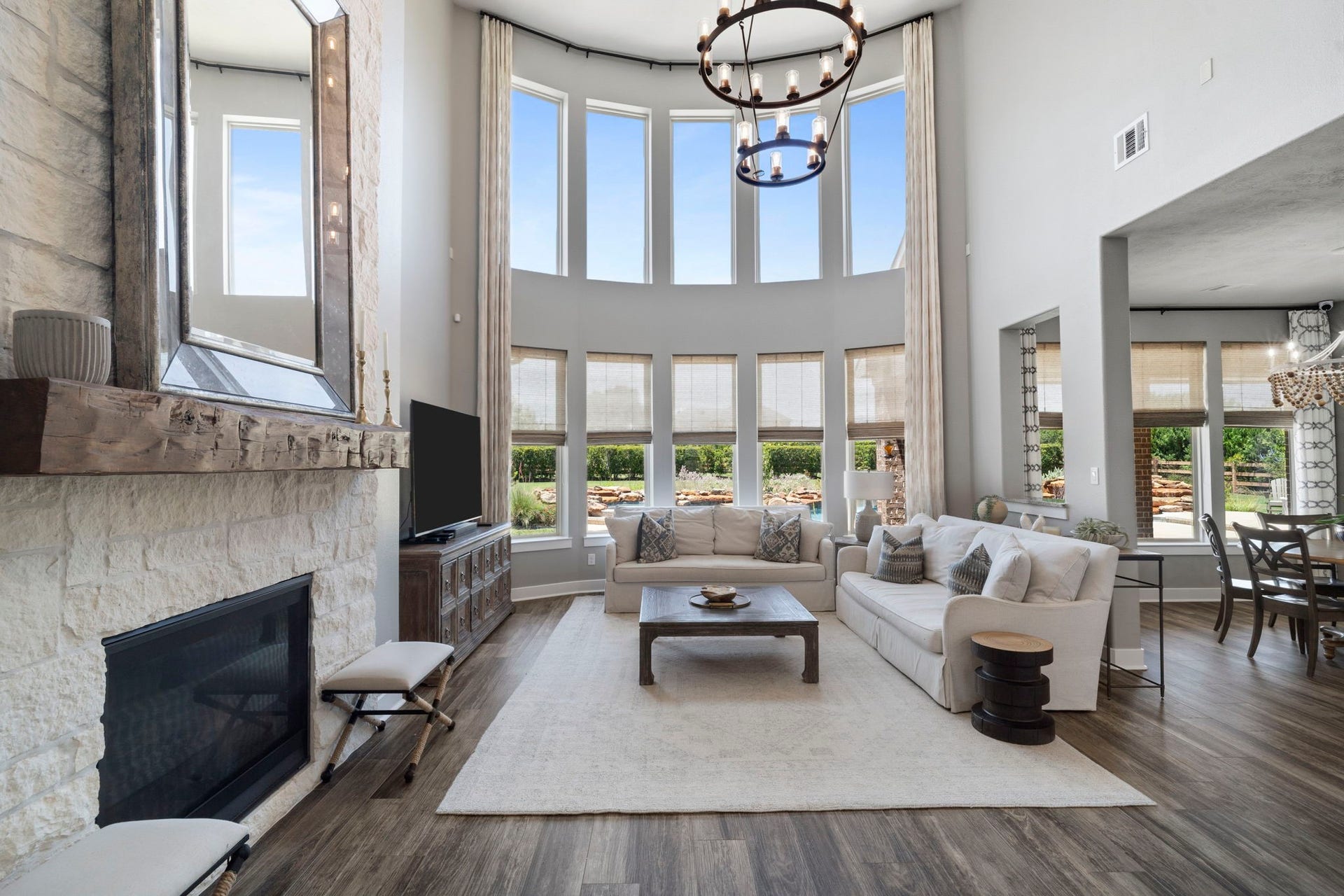 29826 Deer Crest Lane, Fulshear, TX 77406 The dramatic two-story family room is filled with natural light, designer lighting & expansive windows add to the elevated yet comfortable feel.