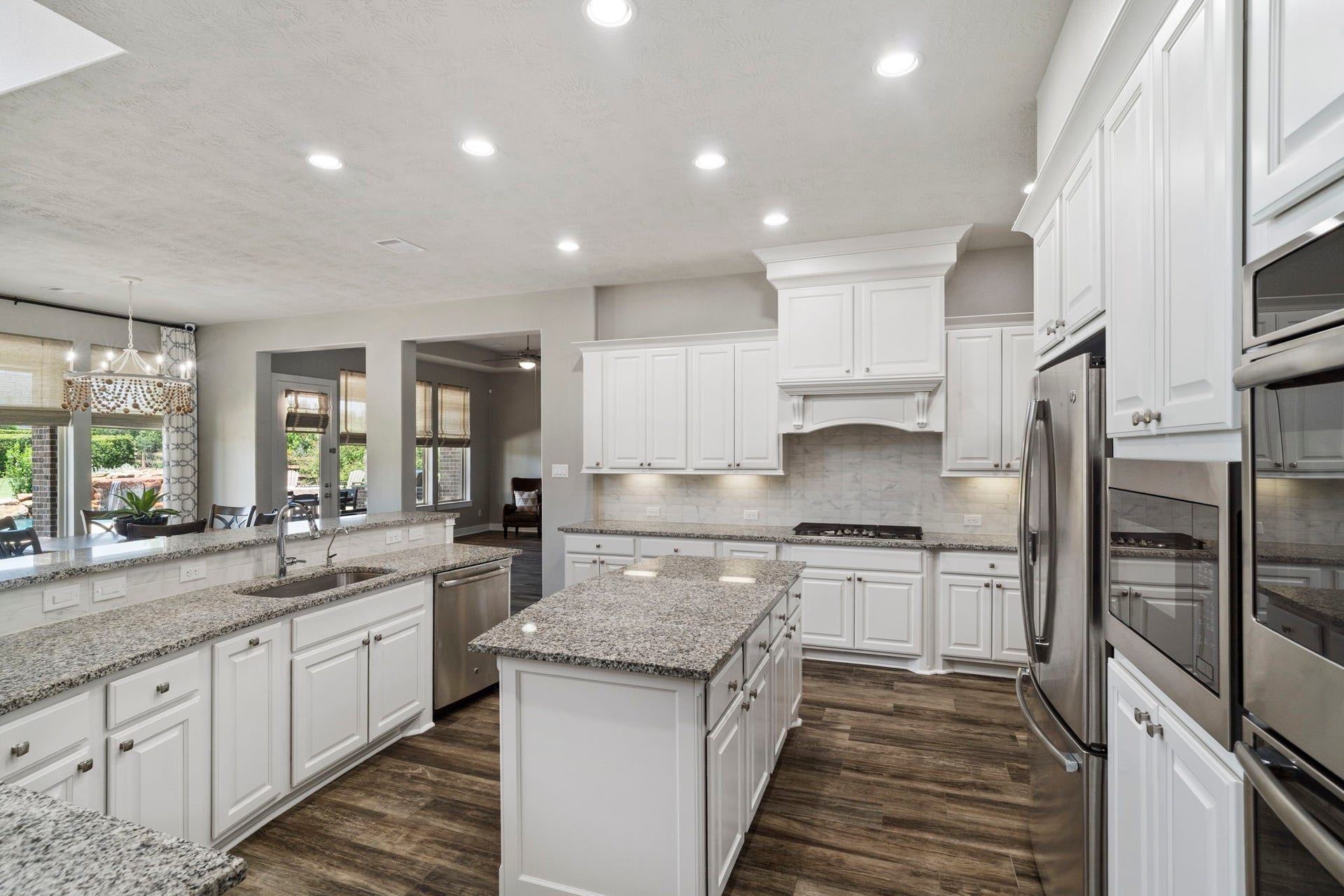 29826 Deer Crest Lane, Fulshear, TX 77406 A generous center island provides additional prep space & storage, while abundant cabinetry, granite countertops and stainless steel appliances create a highly functional kitchen designed for everyday living.