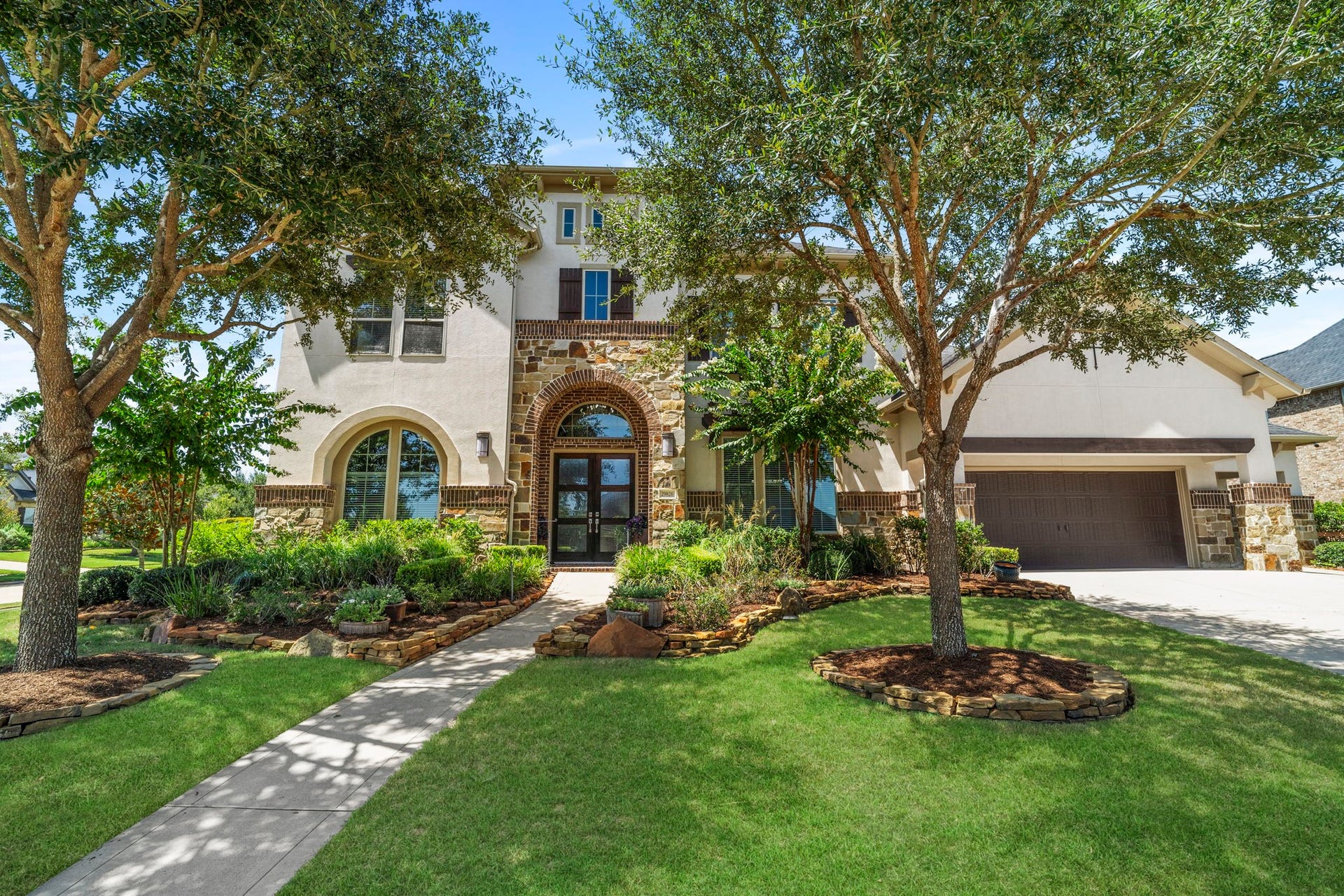 29826 Deer Crest Lane, Fulshear, TX 77406 Positioned on a spacious 1/2-acre corner lot, this impressive home is framed by mature trees, lush landscaping & beautiful stone and brick architectural details.
