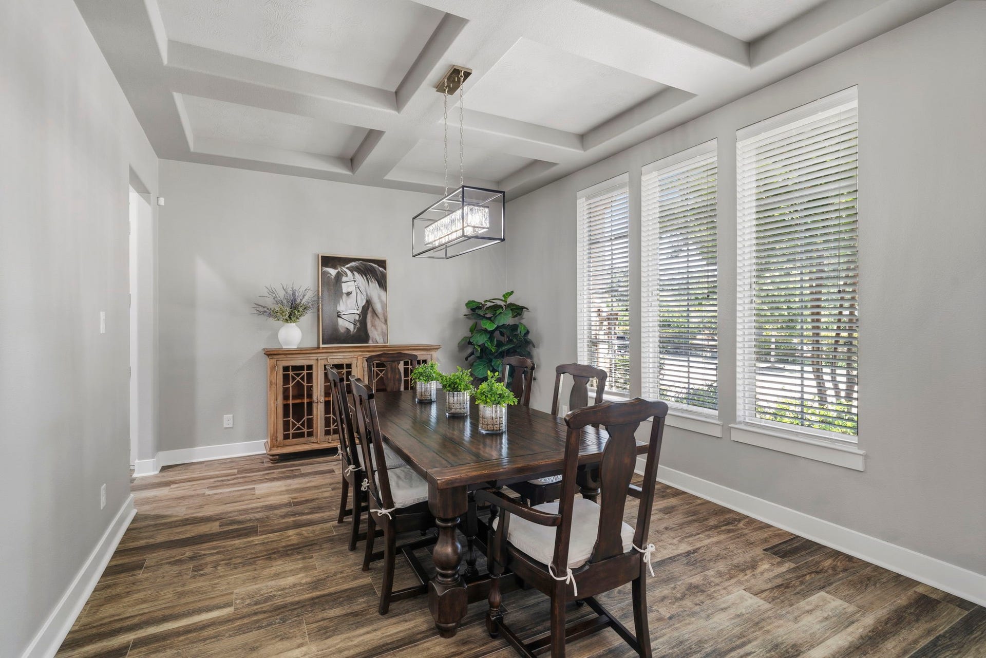 29826 Deer Crest Lane, Fulshear, TX 77406 The formal dining room features a distinctive coffered ceiling, designer lighting & generous space for hosting gatherings both large and intimate.