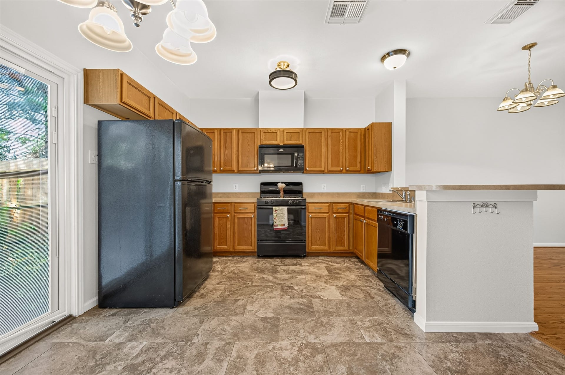 Coordinating black appliances, including a gas range, create a cohesive and functional kitchen space.