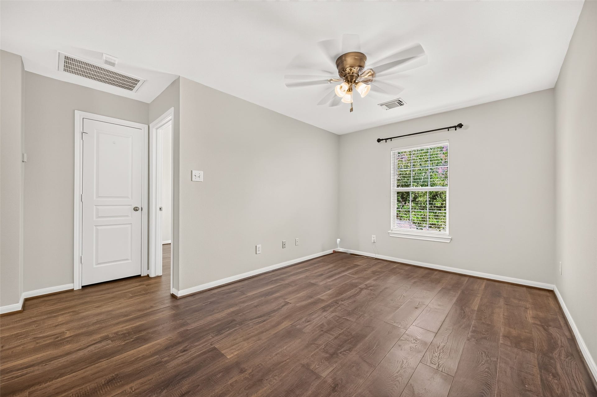The space features abundant natural light, neutral paint (Fresh in 2023), and a ceiling fan for added comfort.