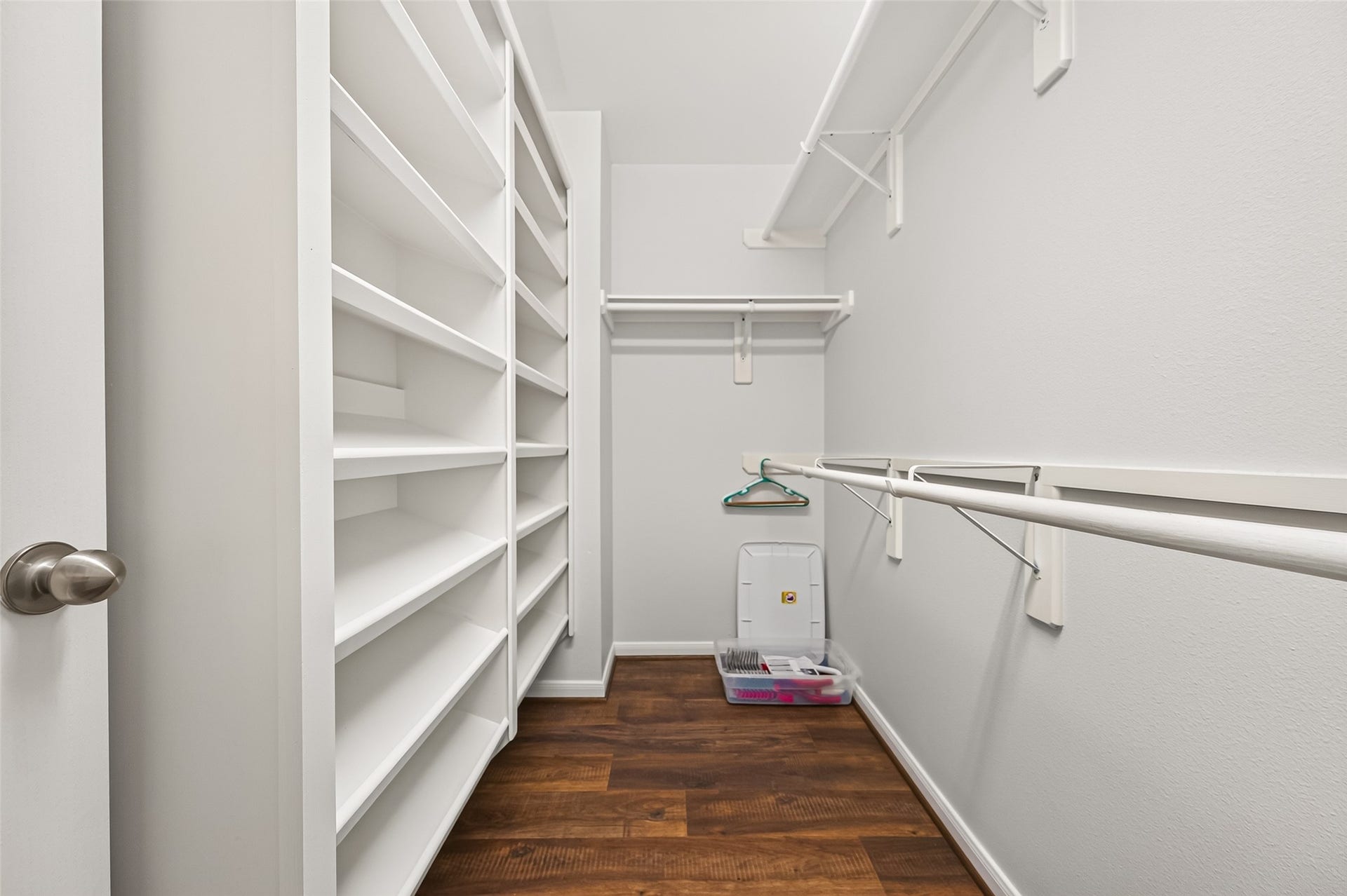 This large primary walk-in closet offers abundant shelving, hanging space, and built-in storage for easy organization.  There is a escape ladder in the closet if the new owner wants to install it.