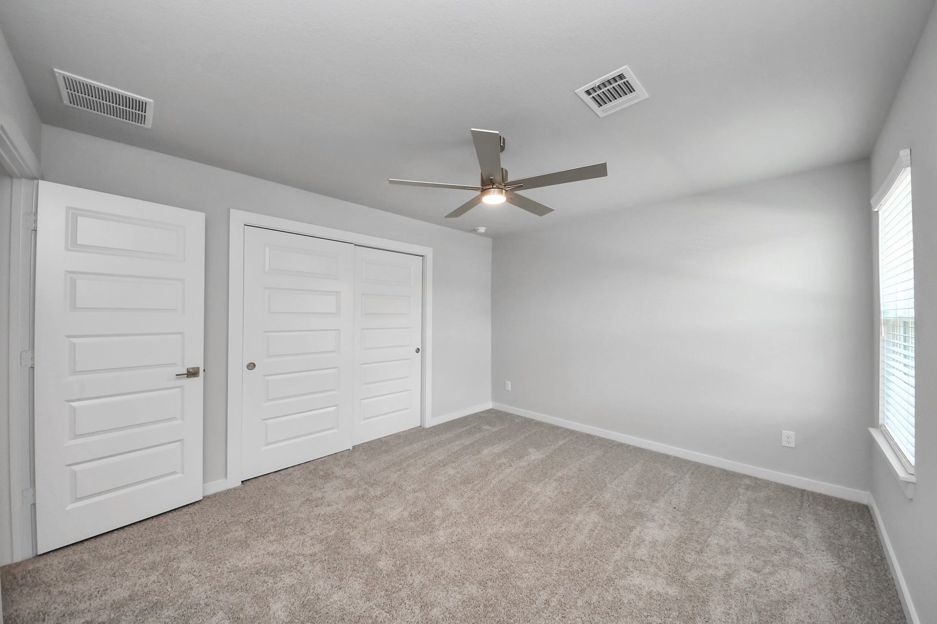 3205 Skerne Spring Drive, Spring, TX 77373 Generously sized secondary bedrooms featuring spacious closets, soft and inviting carpeting underfoot, large windows allowing plenty of natural light, and the added touch of privacy blinds for your personal retreat. Sample photo of completed home with similar floor plan. Actual colors and selections may vary.