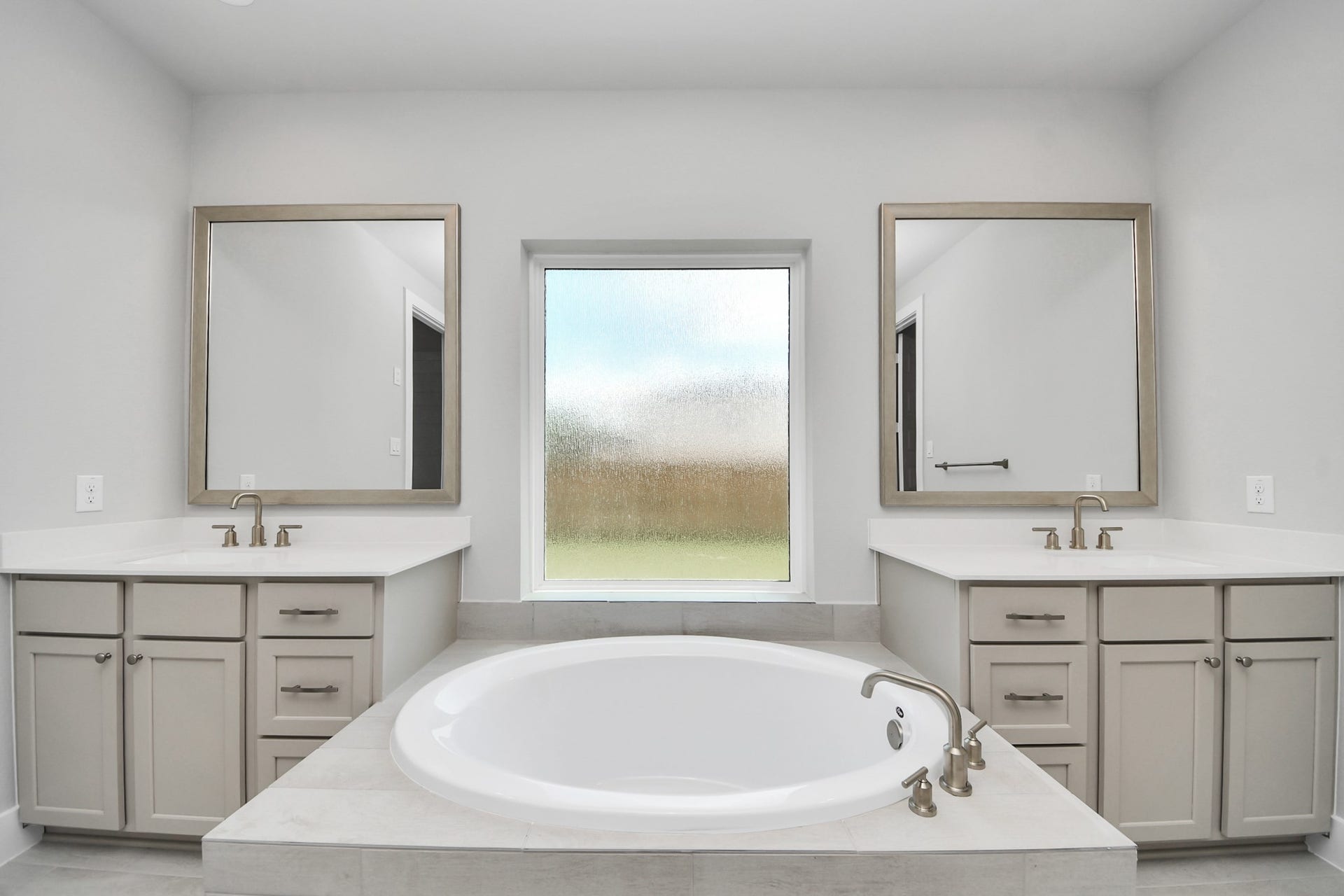 3205 Skerne Spring Drive, Spring, TX 77373 Indulge in a spa-like retreat within the confines of this primary bathroom. Delight in a spacious walk-in shower enveloped in stylish tile surround, unwind in a separate garden tub adorned with custom detailing. Sample photo of completed home with similar floor plan. Actual colors and selections may vary.