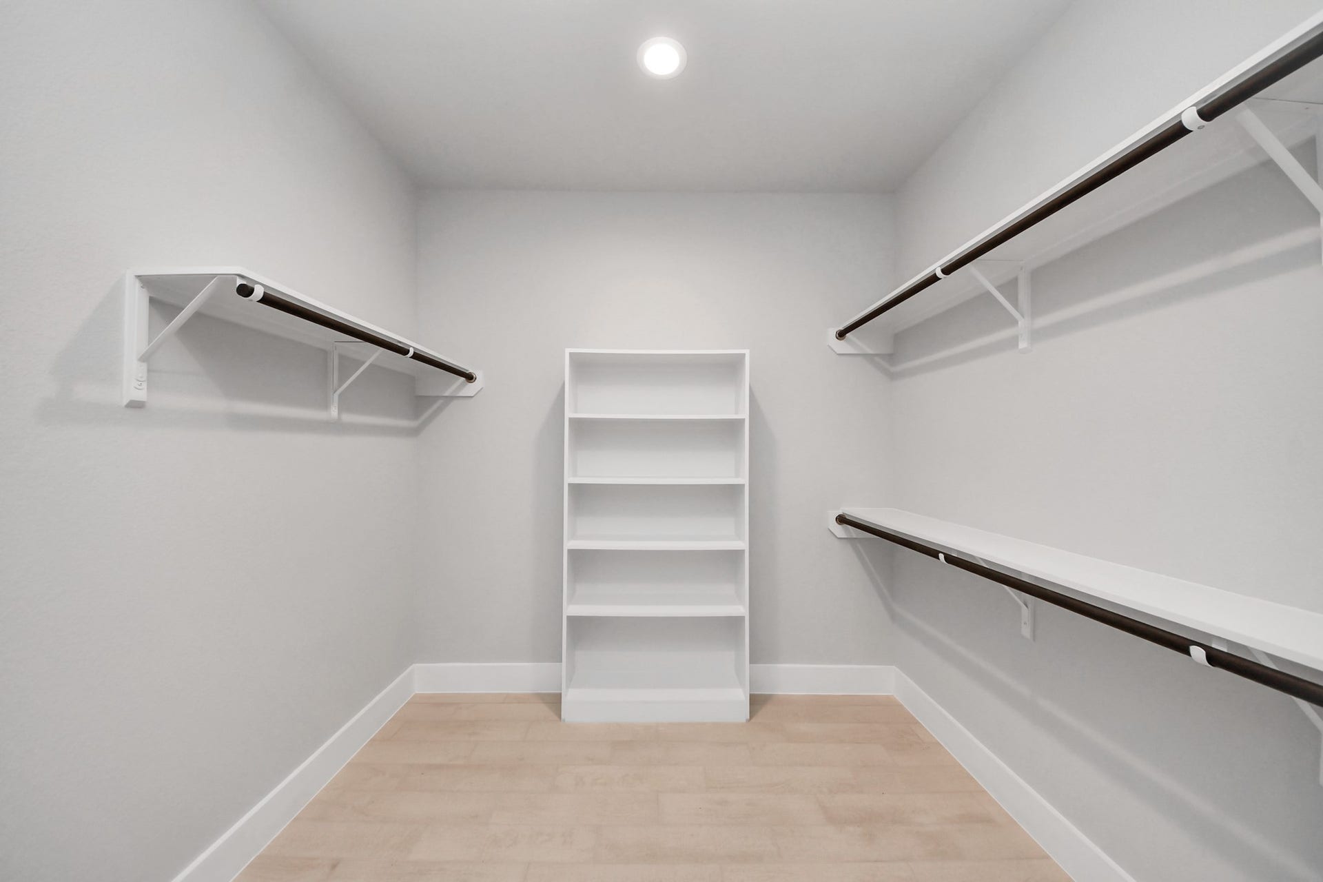 3205 Skerne Spring Drive, Spring, TX 77373 Walk-in closet that epitomizes luxury and practicality. This generously sized space features built-in shelving, offering abundant room for impeccable organization. High ceilings and recessed lighting create a bright and welcoming ambiance. Sample photo of completed home with similar floor plan. Actual colors and selections may vary.