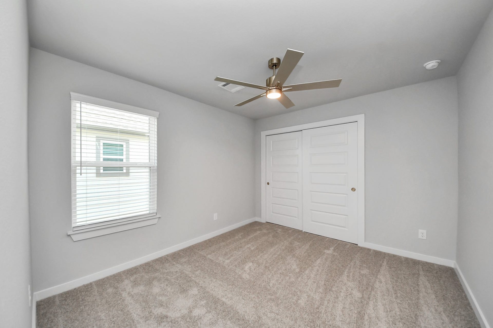 3205 Skerne Spring Drive, Spring, TX 77373 Secondary bedroom features plush carpeting, large windows that let in plenty of natural light, bright paint, and spacious closets. Sample photo of completed home with similar floor plan. Actual colors and selections may vary.