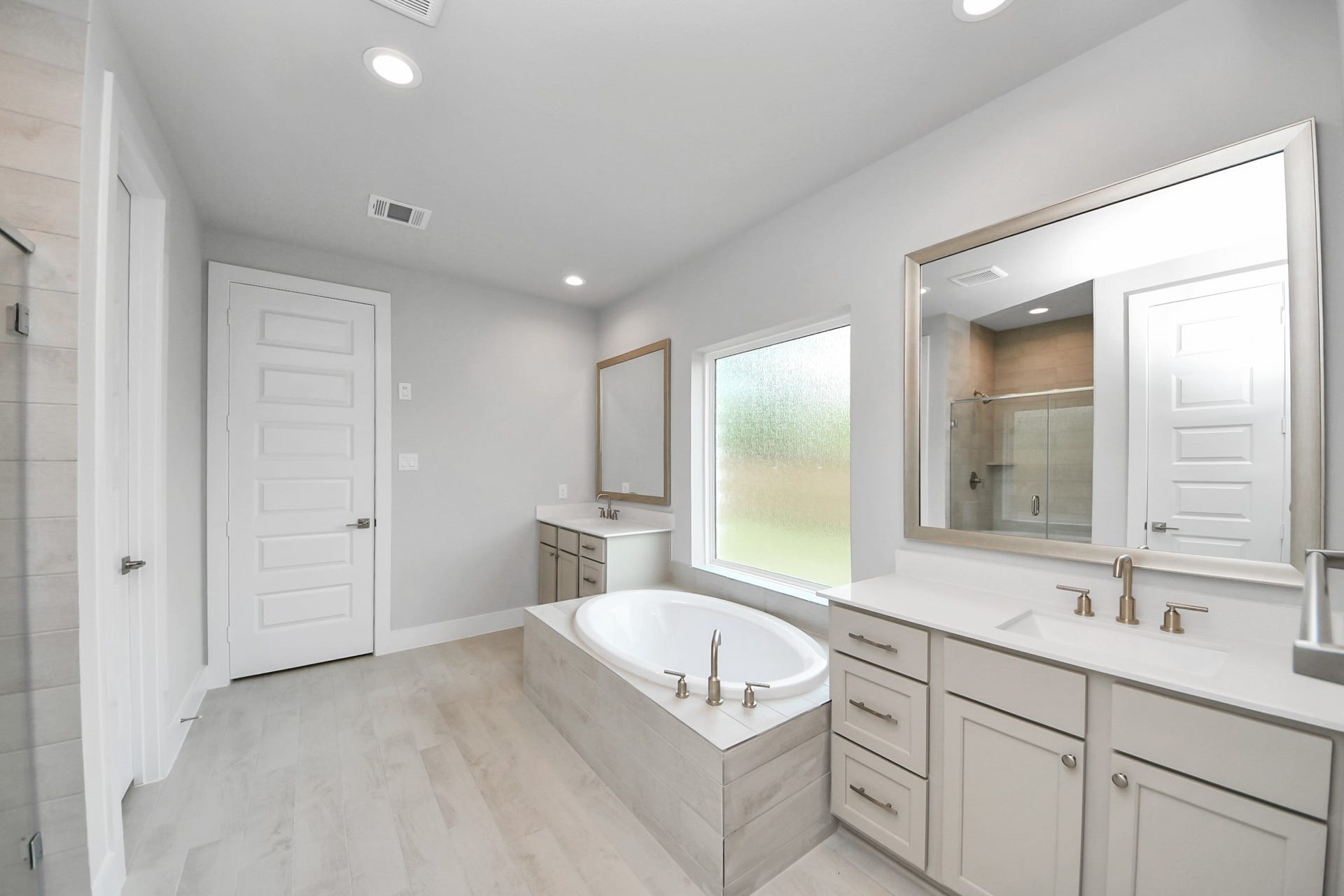 3205 Skerne Spring Drive, Spring, TX 77373 Indulge in the serenity of your primary bathroom, a true retreat designed for relaxation. The spacious walk-in shower, encased in elegant tile, invites you to unwind, while the separate garden tub, featuring unique, custom details, offers a perfect place for soaking away the day's stresses. Sample photo of completed home with similar floor plan. Actual colors and selections may vary.