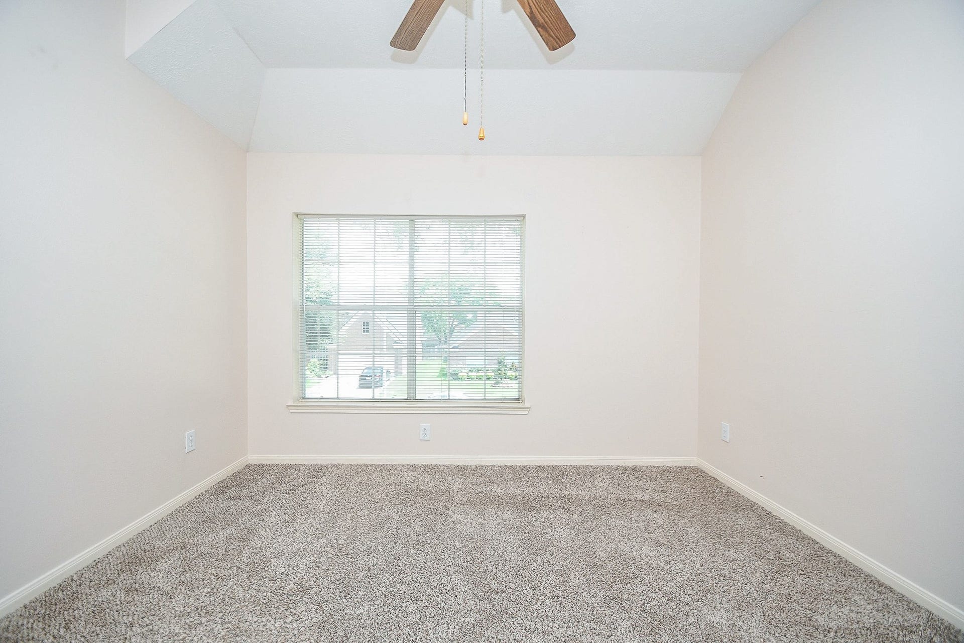 15715 Brookwood Lake Place, Sugar Land, TX 77498 This room features neutral walls, plush carpet, and a large window for natural light. A ceiling fan provides comfort and the space is versatile for various uses.