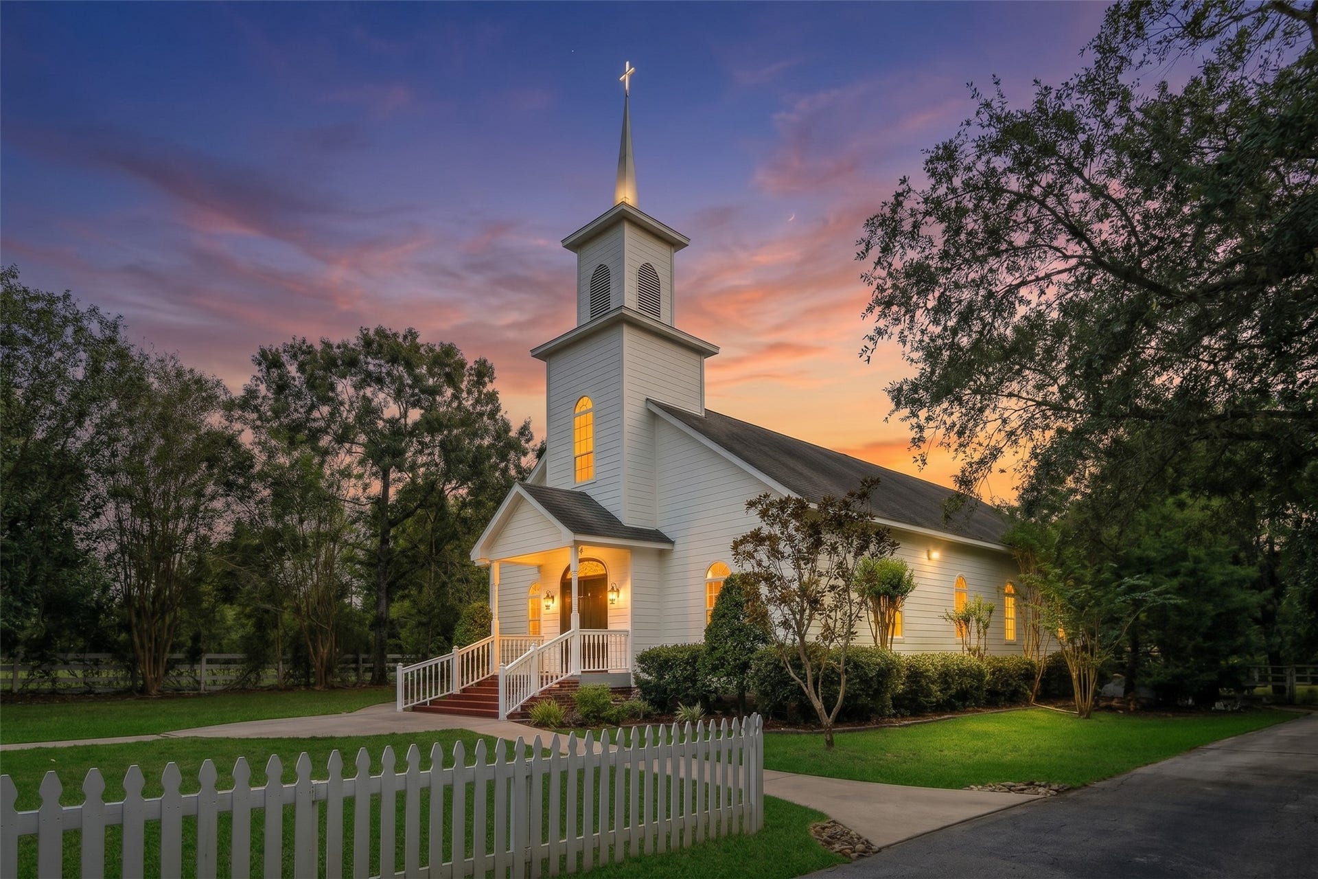 Charming white chapel provides a beautiful setting for weddings, vow renewals, and special ceremonies, surrounded by picturesque grounds and mature trees.