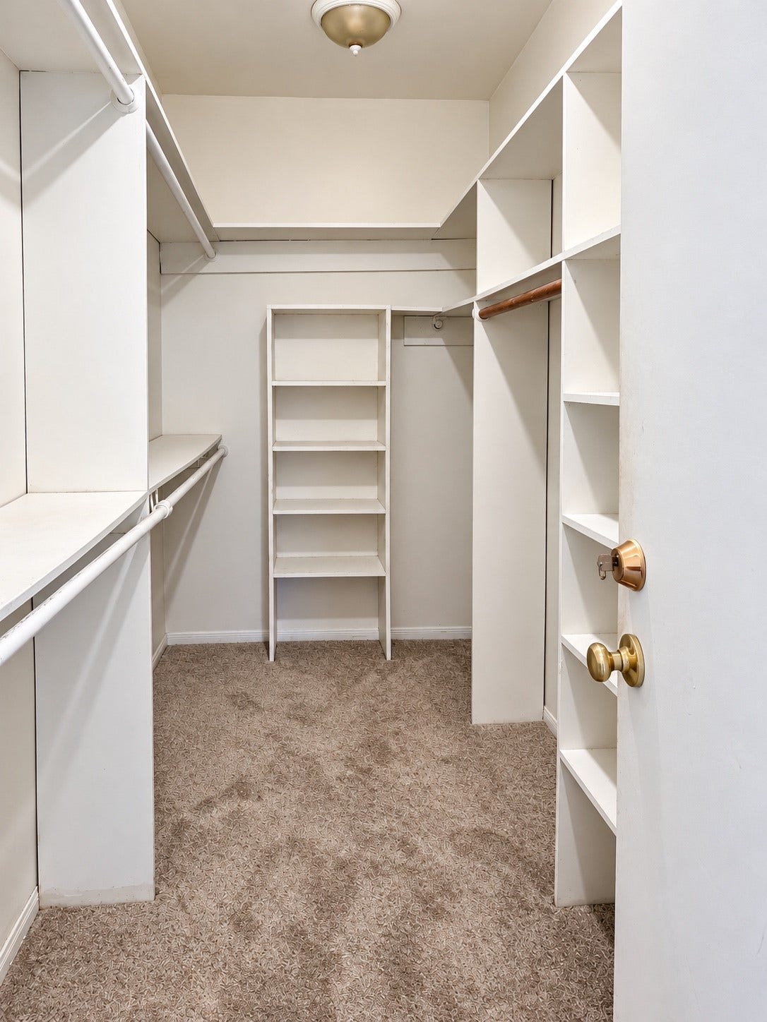 11711 Memorial Drive, #313, Houston, TX 77024 Spacious walk-in-closet with built-in shelving and multiple hanging rods for east organizing.