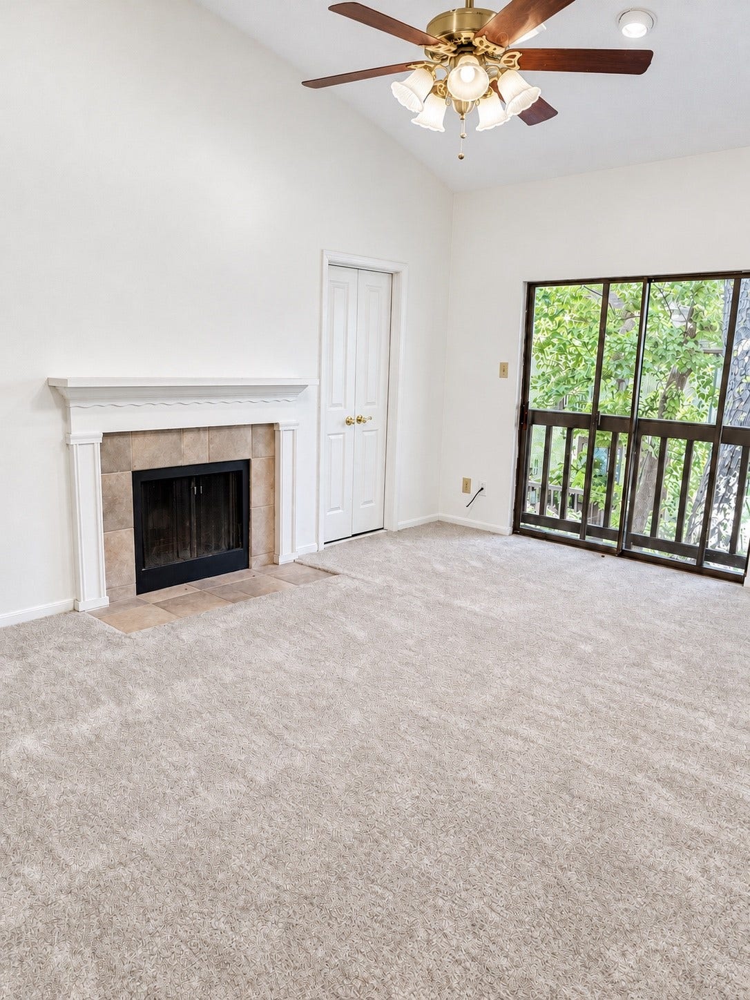 11711 Memorial Drive, #313, Houston, TX 77024 Cozy Primary Bedroom/Retreat with a fireplace, Vaulted ceiling, and sliding glass door opening to your peaceful balcony with leafy view.