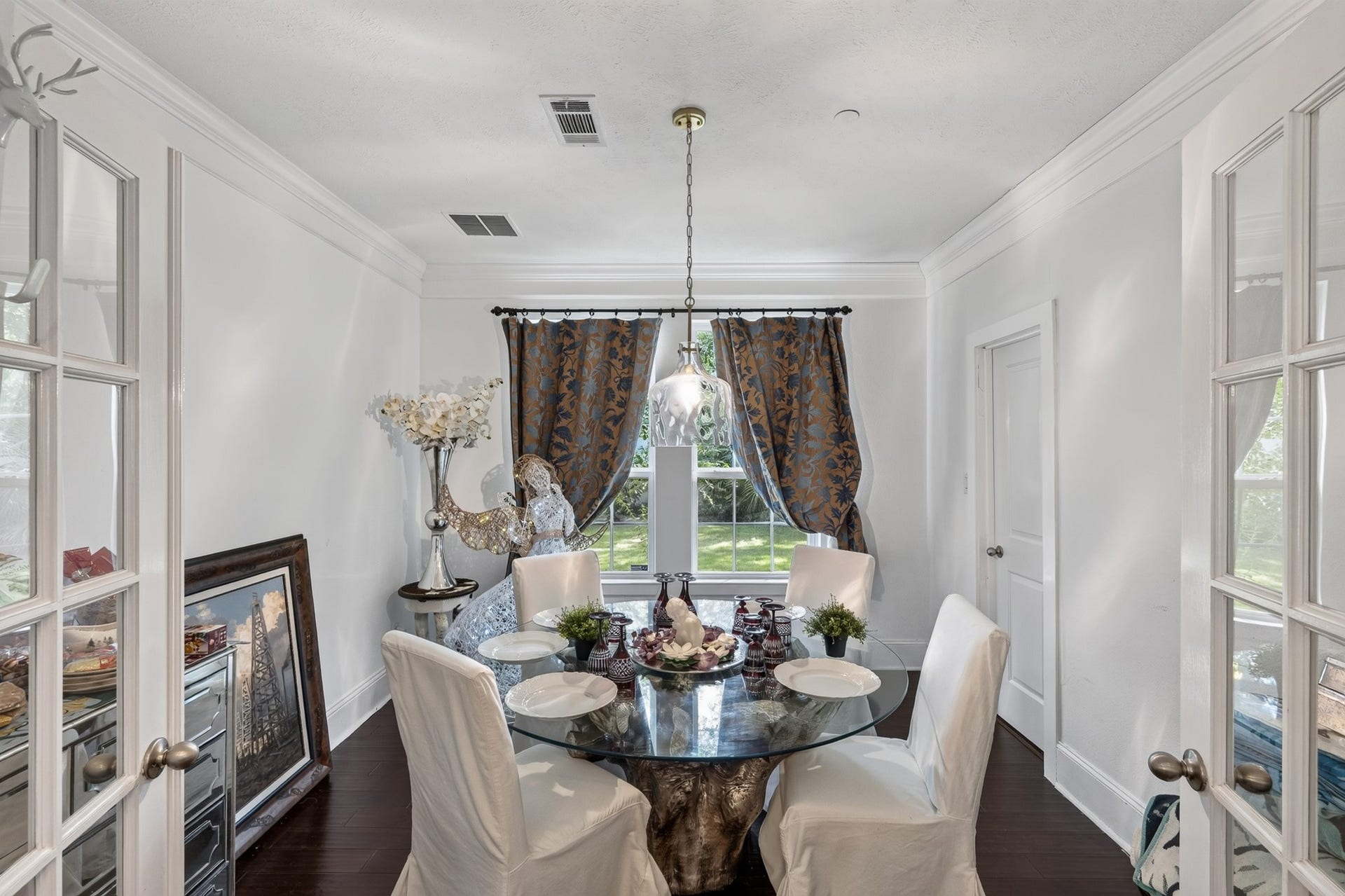 Formal dining room with French door enhanced by classic architectural details.