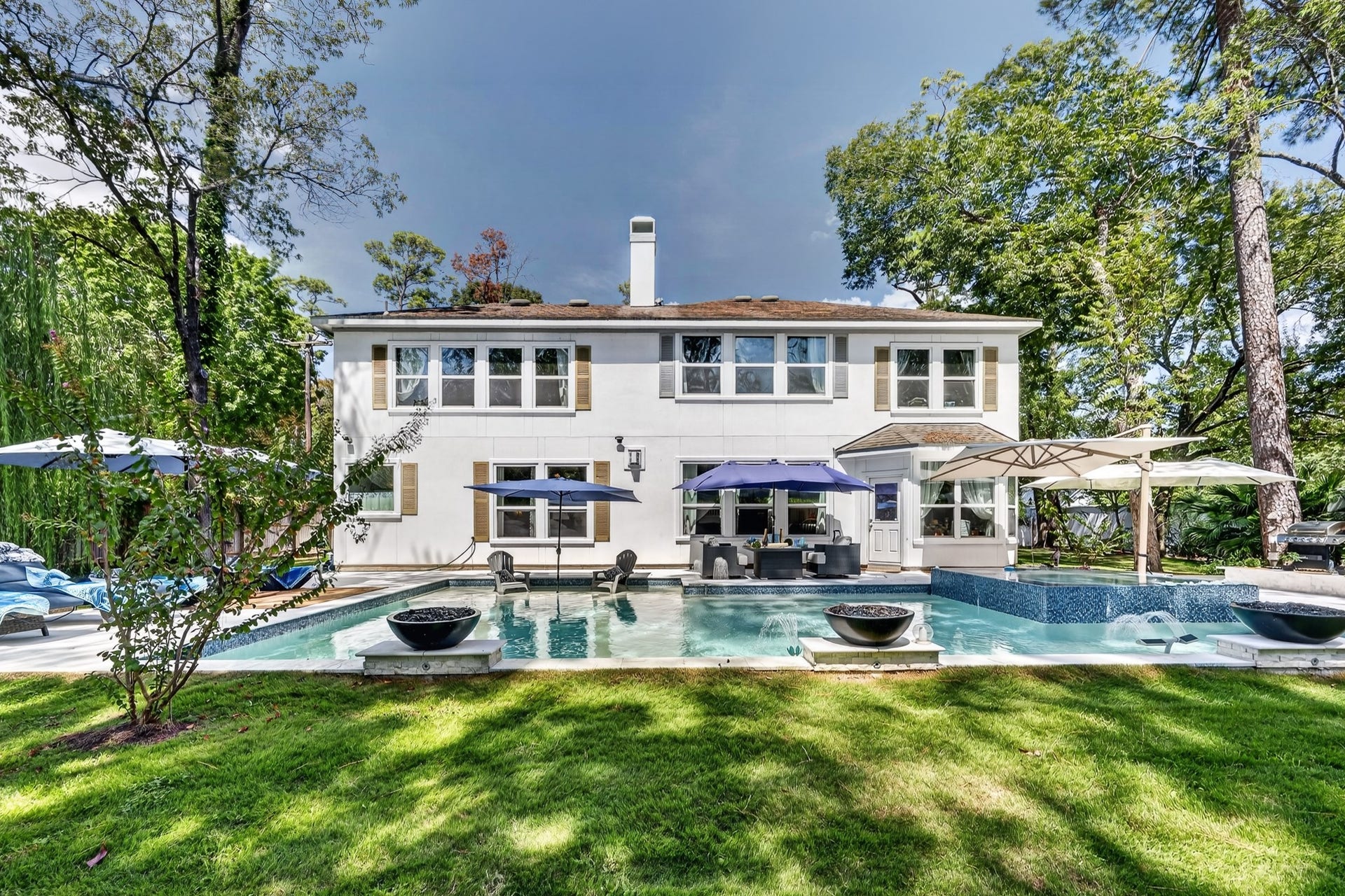 Stunning estate with elegant architecture and resort-style pool.