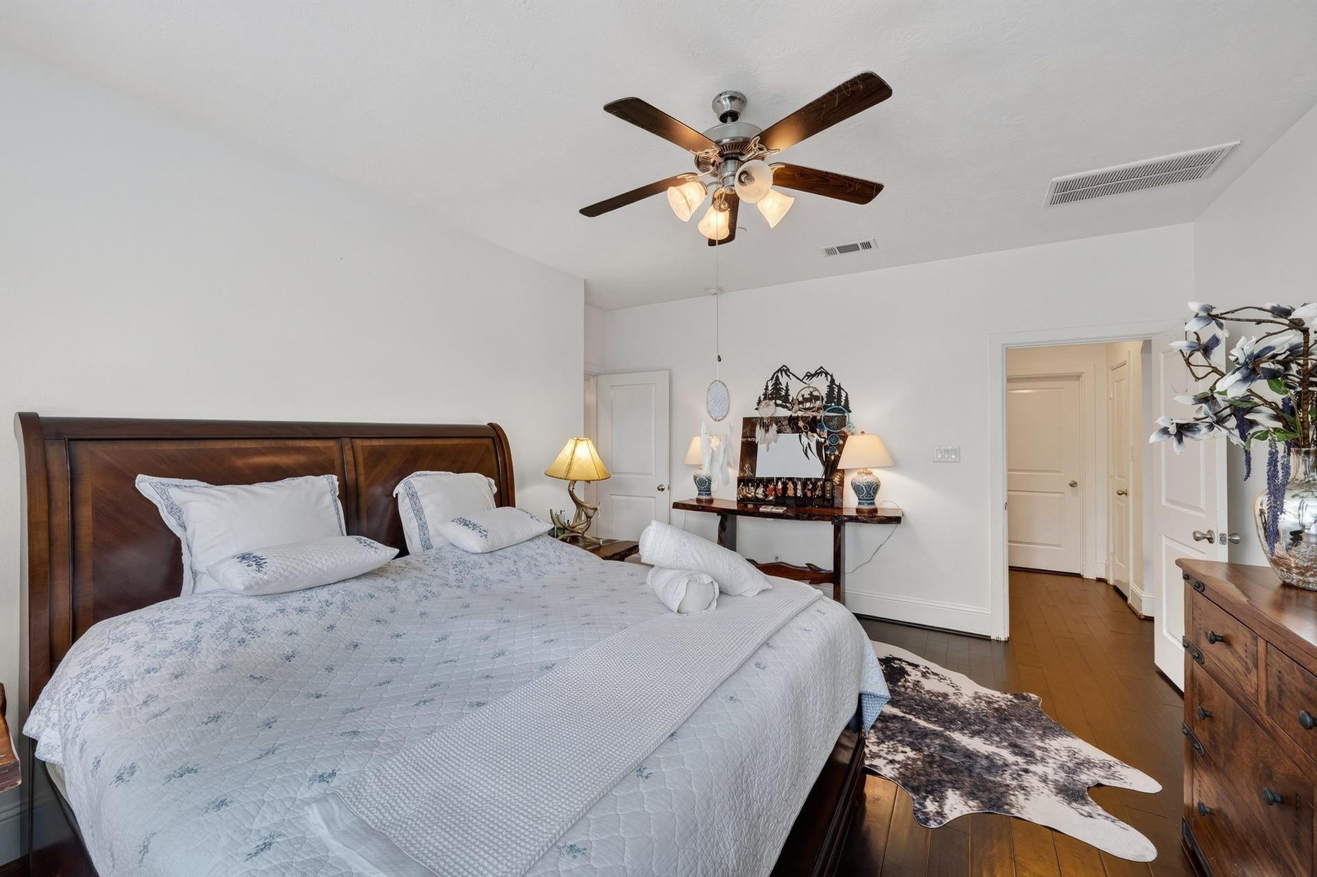 Downstairs primary bath features dual vanities and quality finishes.