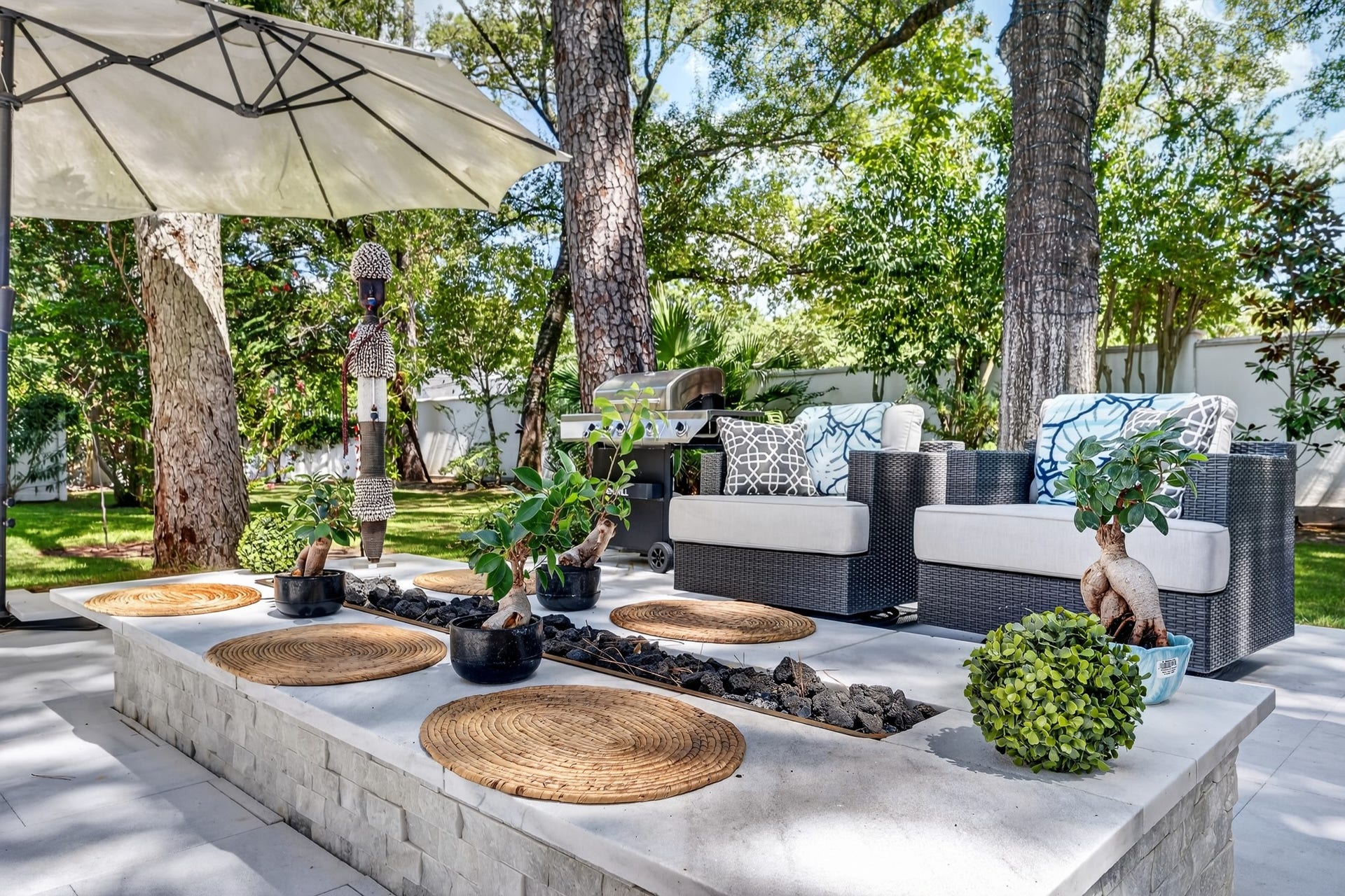 Private patio retreat featuring designer seating and a cozy fire feature.
