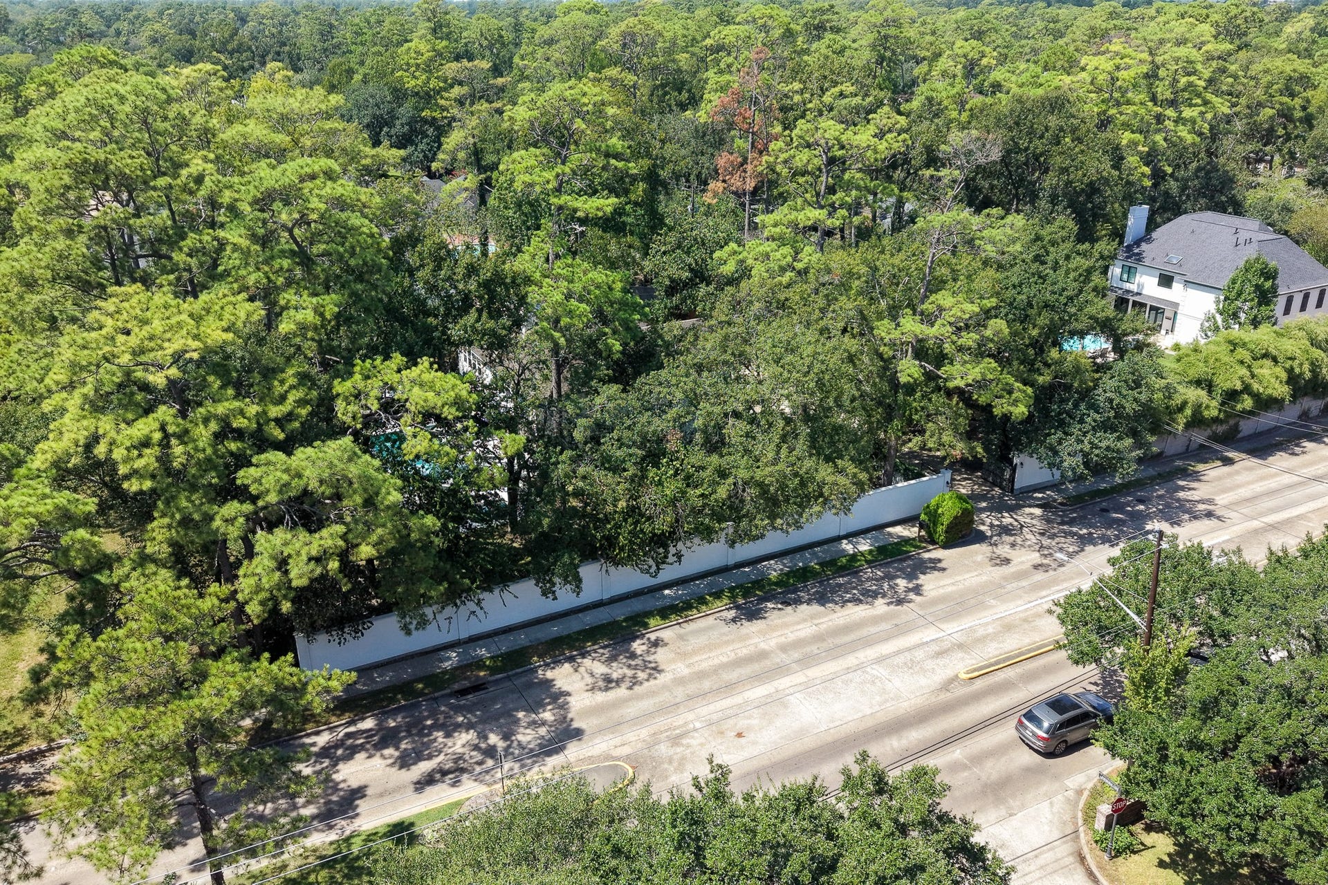 Aerial view highlighting the estate's serene, wooded setting.