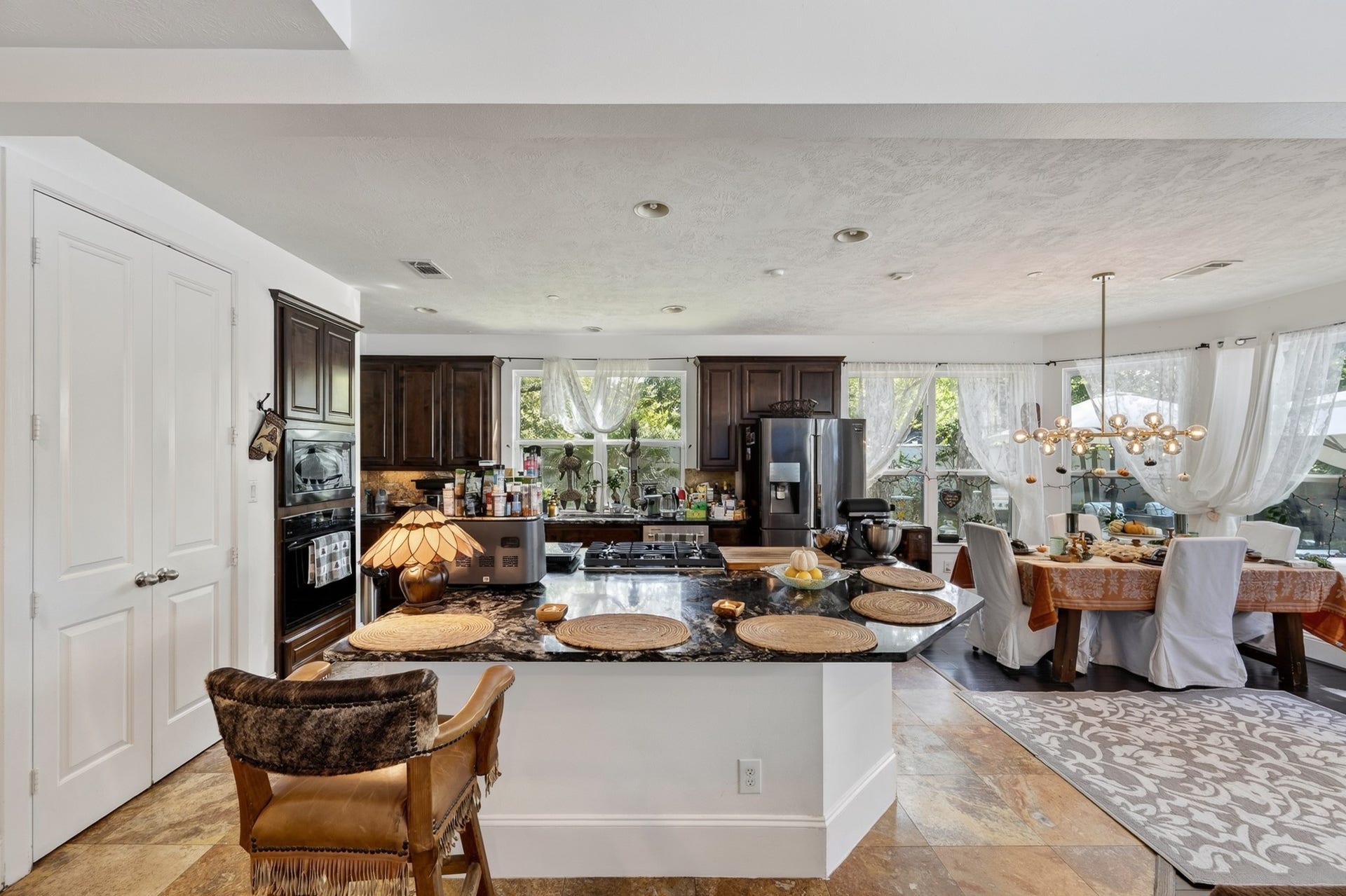 Beautifully appointed kitchen with expansive island seating, premium finishes, and seamless connection to the breakfast room.