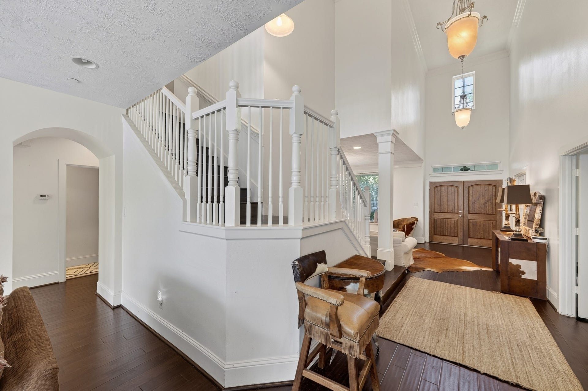 Gracious interior highlighted by a sweeping staircase and open-concept design.