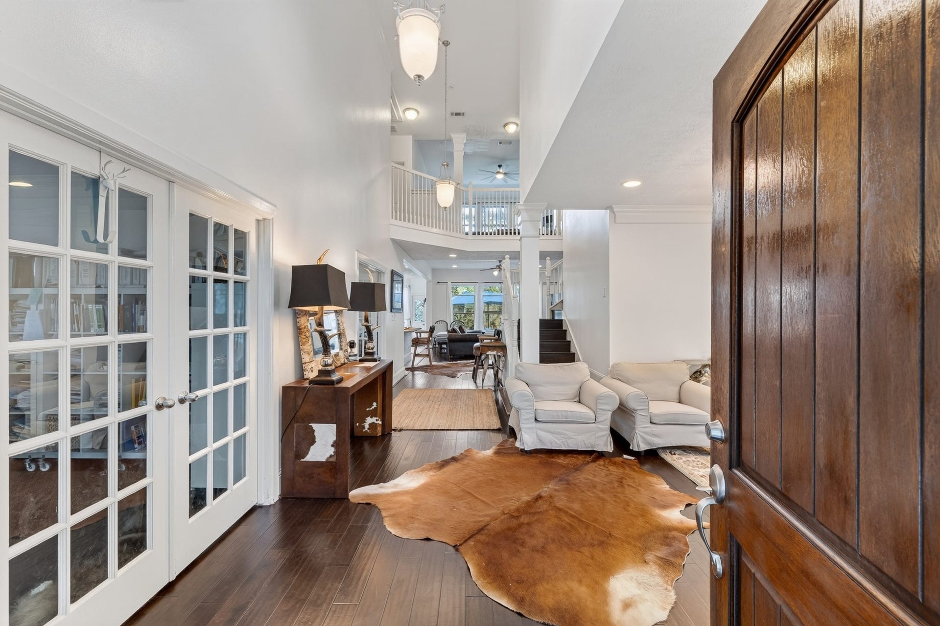 Two Sophisticated French door - study rooms featuring rich wood accents.