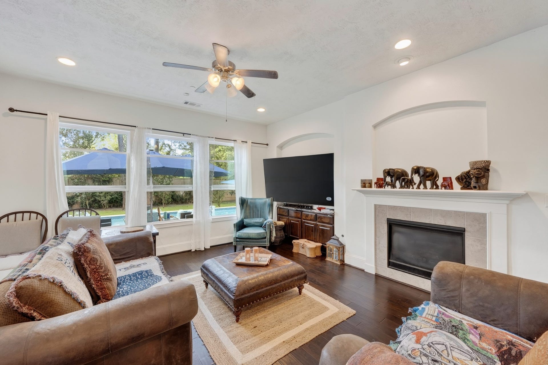 Bright and spacious family room anchored by a fireplace and built-ins overlooking expandable, over-the deck patio.