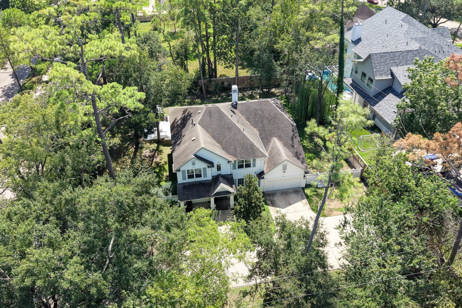 Private retreat nestled among secular and pine trees in an exclusive enclave.