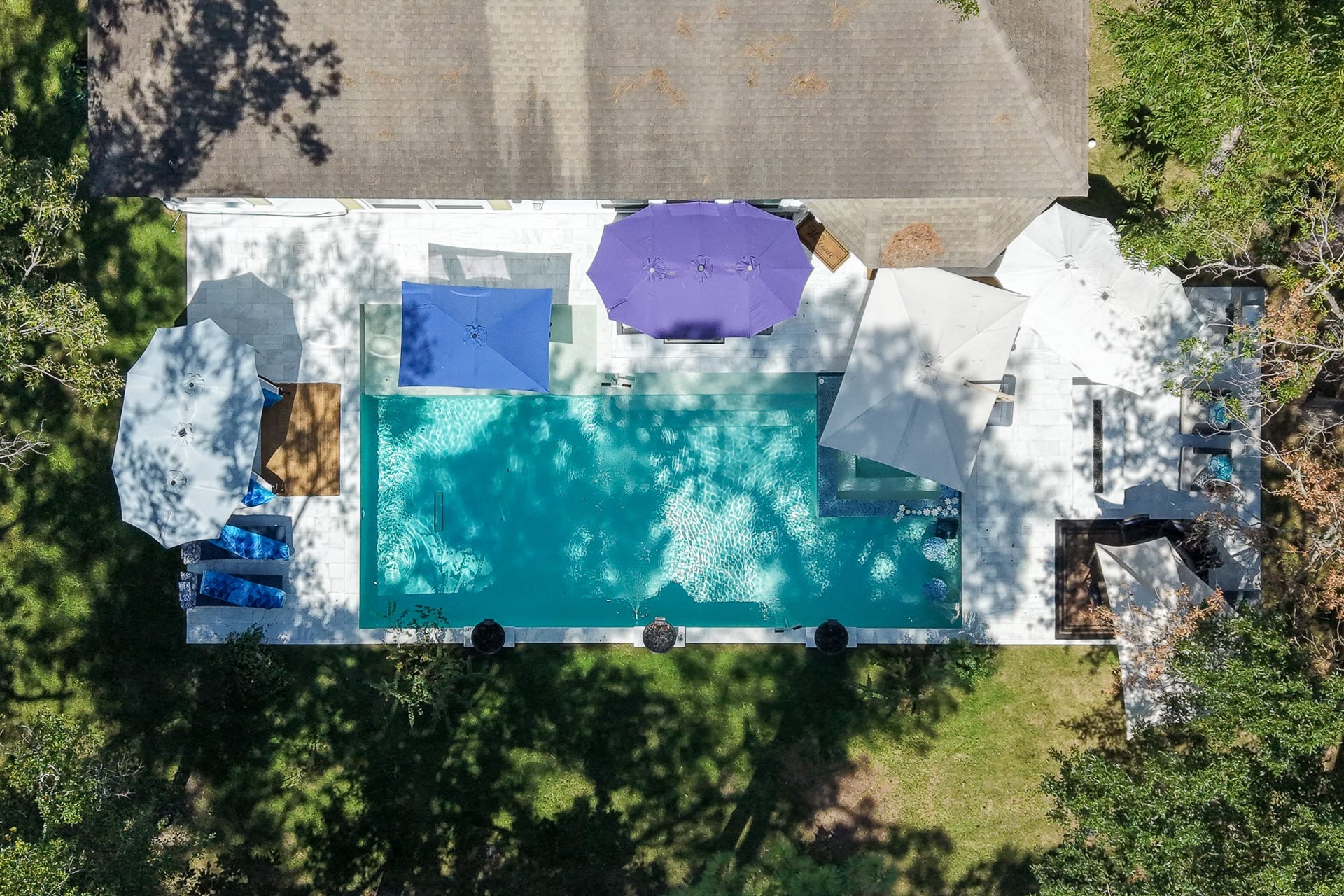 Stunning aerial perspective of the pool, spa, and outdoor living spaces.