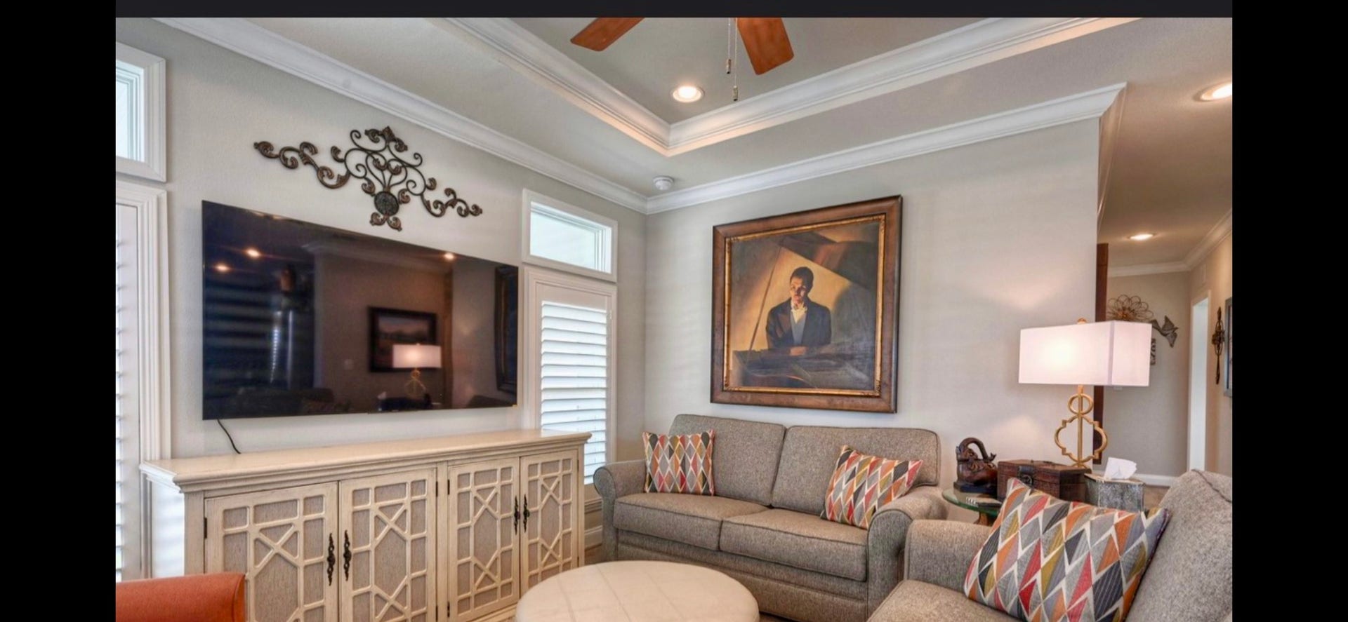 11720 Thousand Trails Road, #73, Willis, TX 77318 Comfortable living area features upgraded laminate flooring, crown molding & a decorative ceiling with a fan. Windows with shutters & transoms add character & natural light.