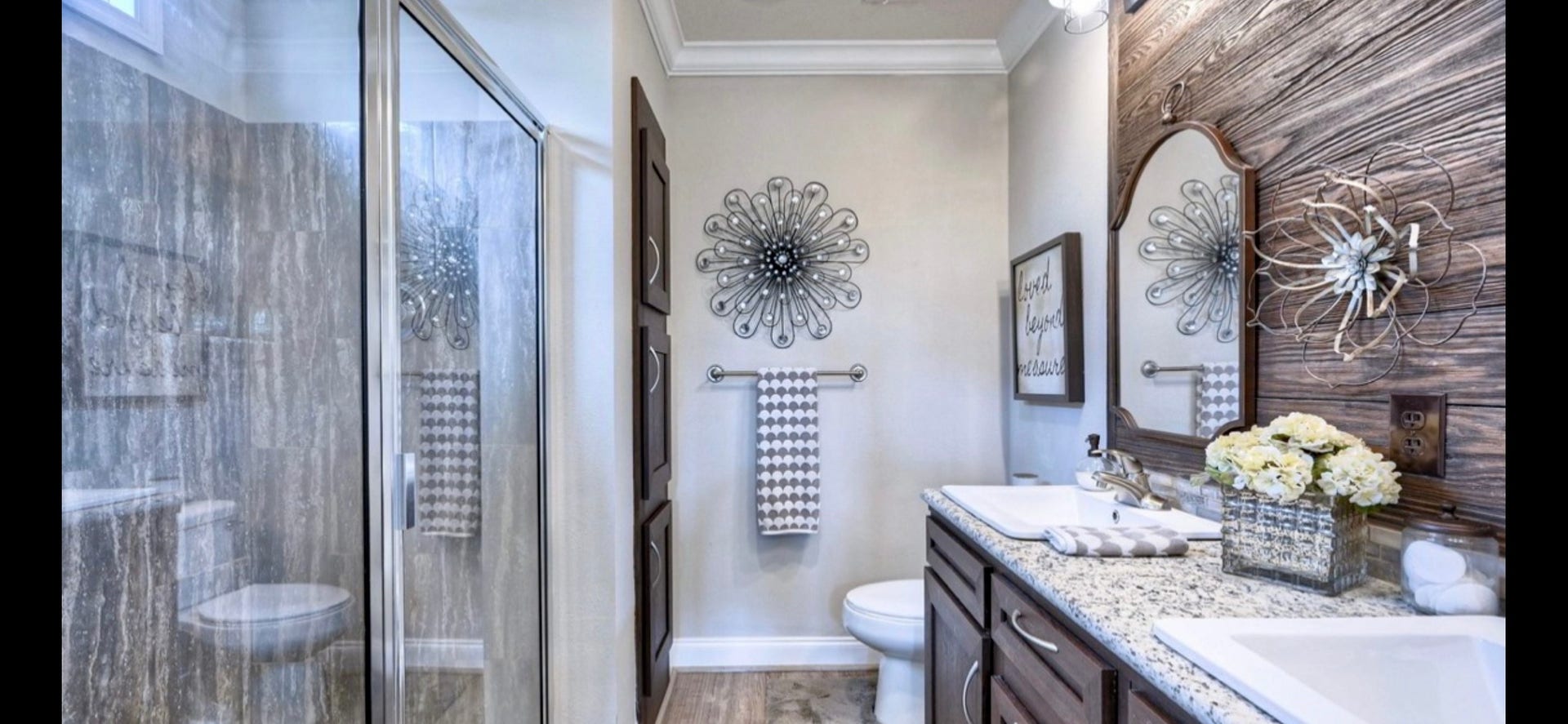 11720 Thousand Trails Road, #73, Willis, TX 77318 Primary bath features a separate shower & double-sink vanity, with decorative finishes that complement the homes interior.