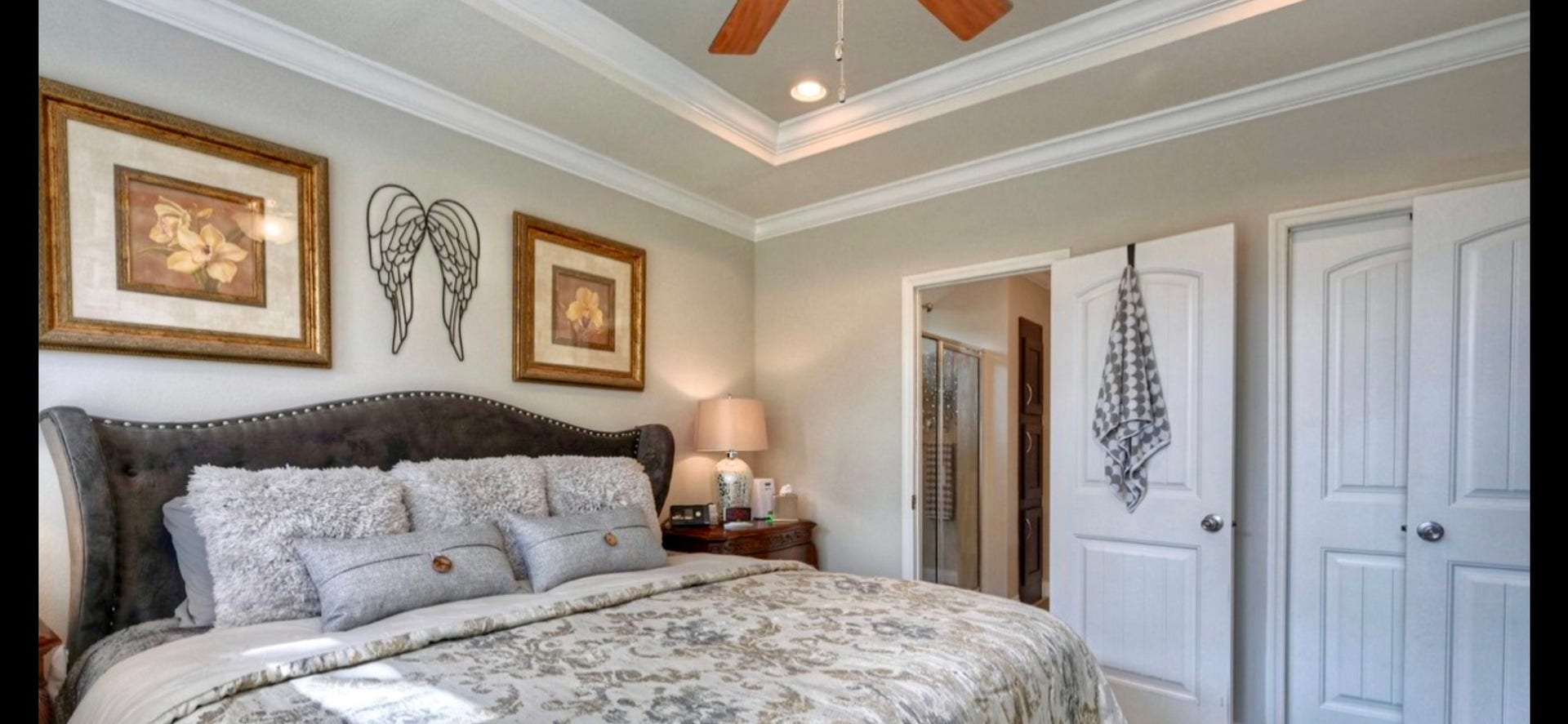 11720 Thousand Trails Road, #73, Willis, TX 77318 Relax in the primary bedroom featuring a decorative tray ceiling, crown molding & ceiling fan. Suite includes a walk-in closet & private bath.