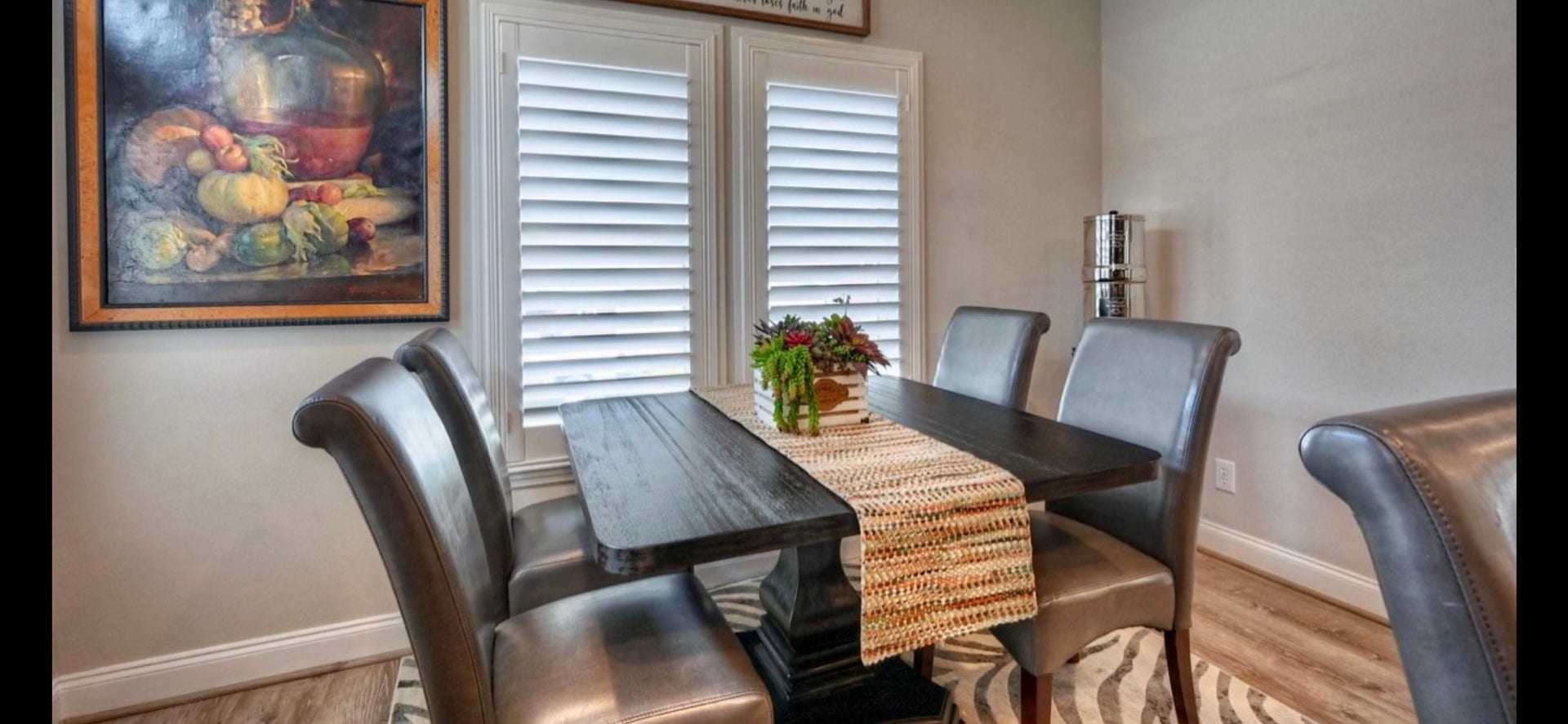 11720 Thousand Trails Road, #73, Willis, TX 77318 Inviting dining space sits beside shuttered windows, offering natural light & a convenient location just off the kitchen.