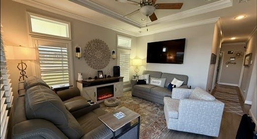 11720 Thousand Trails Road, #73, Willis, TX 77318 Inviting living room features a tray ceiling, crown molding, transom windows & upgraded flooring. TV & TV mounts are included.