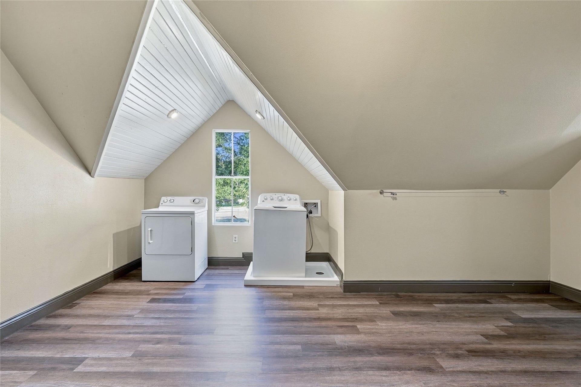24904 Robin Hood Lane, Hockley, TX 77447 Upstairs laundry and bonus room featuring washer and dryer connections, natural light, and generous additional floor space.