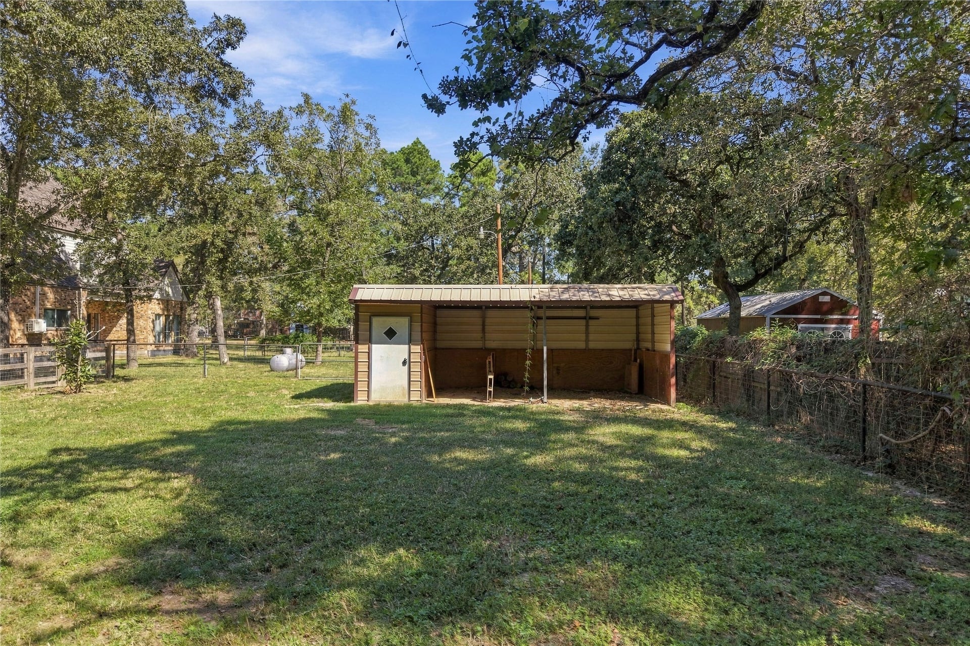 24904 Robin Hood Lane, Hockley, TX 77447 Horse stall with covered bays and enclosed storage space, offering added functionality for the property.