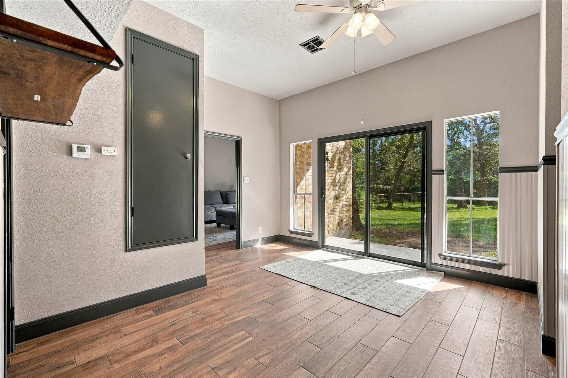 24904 Robin Hood Lane, Hockley, TX 77447 View from the kitchen into the breakfast room, featuring wood-look flooring, abundant natural light, and convenient access to the adjoining family room.