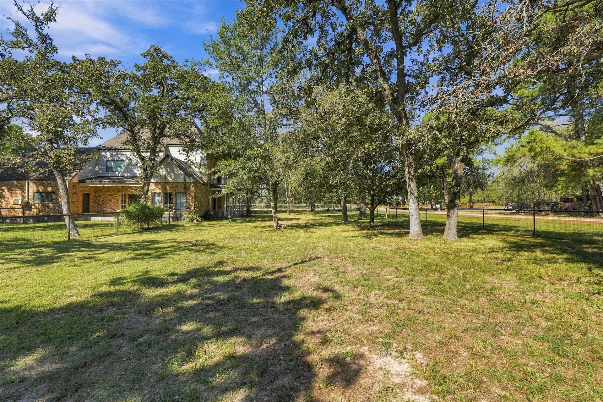 24904 Robin Hood Lane, Hockley, TX 77447 Expansive side yard with mature shade trees, fencing, and plenty of open green space to enjoy.