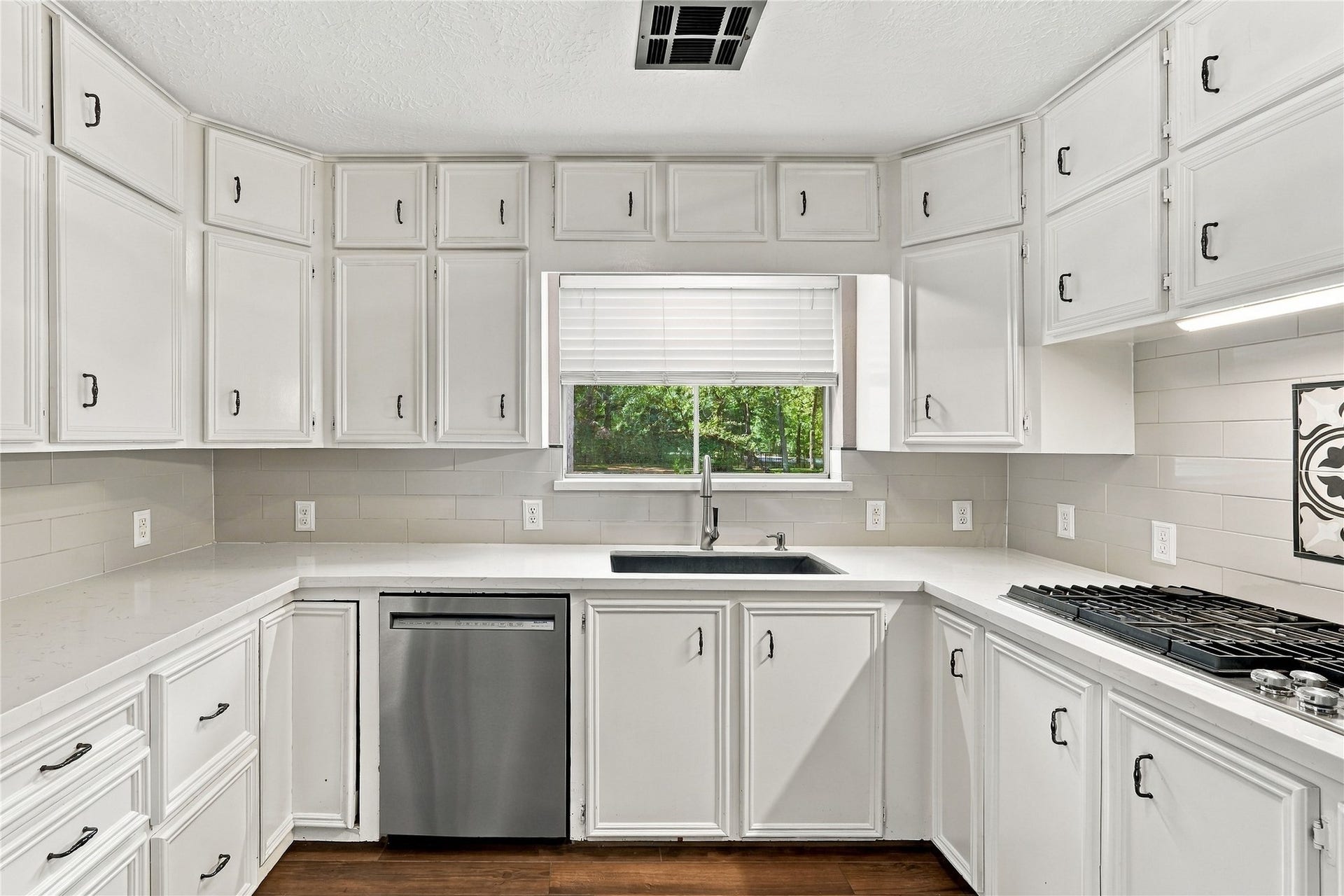 24904 Robin Hood Lane, Hockley, TX 77447 Additional kitchen view highlighting abundant cabinet storage, generous counter space, stainless steel dishwasher, and window overlooking the backyard.