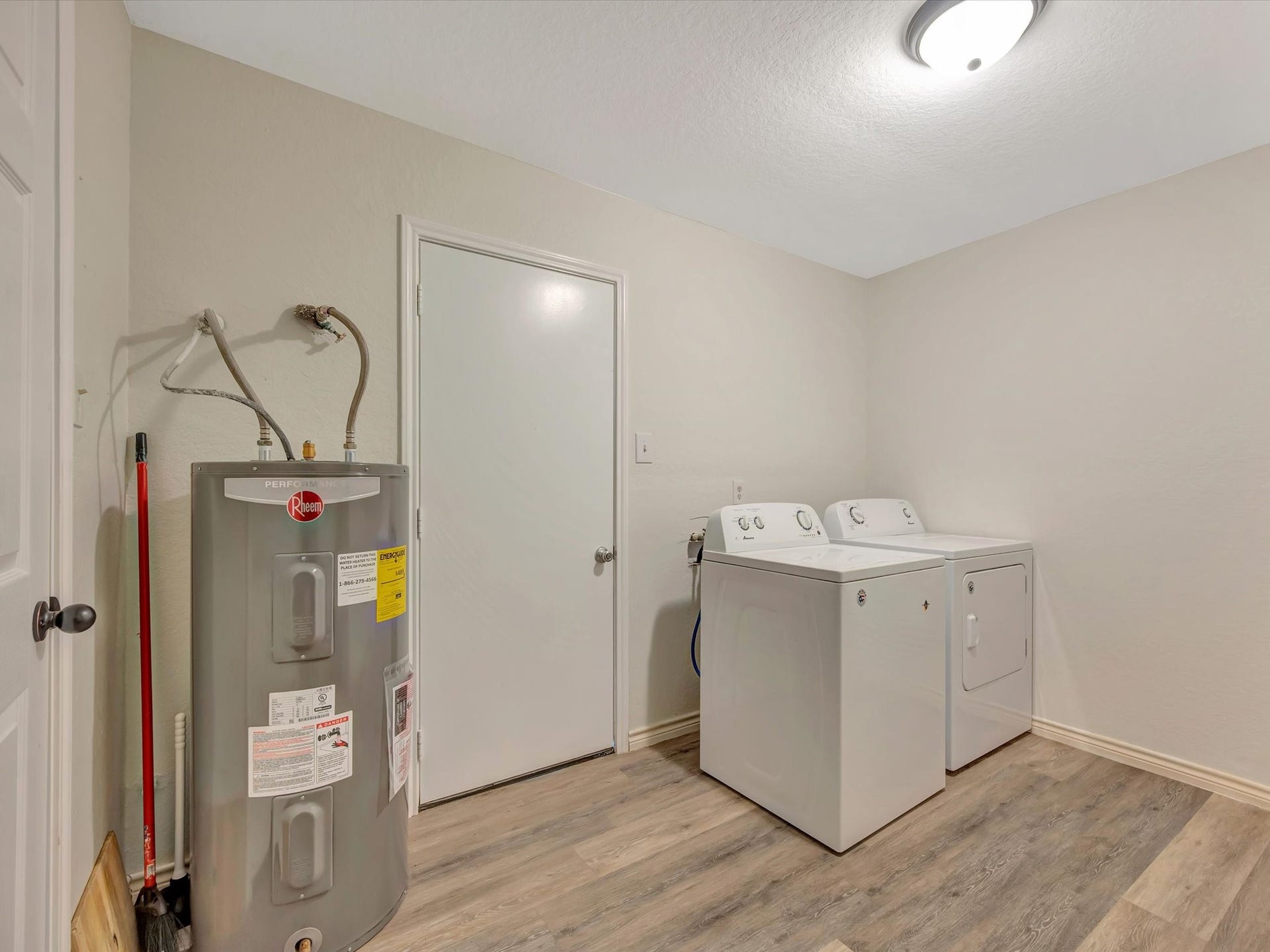 7230 Avenue L, Santa Fe, TX 77510 Utility room with laundry hookups and storage space.