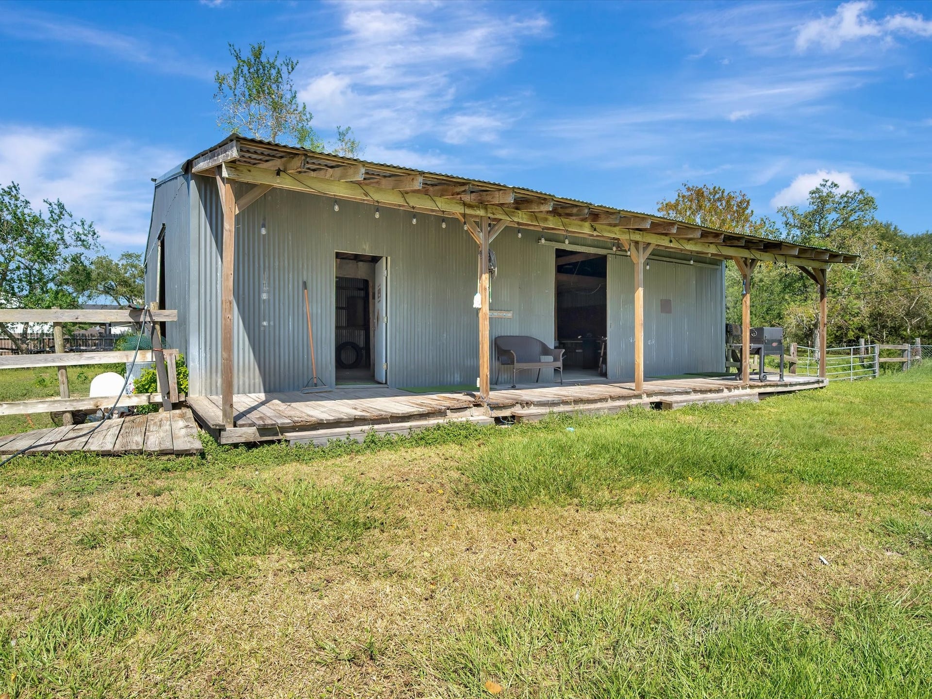 7230 Avenue L, Santa Fe, TX 77510 Front porch view of the barn and shop.