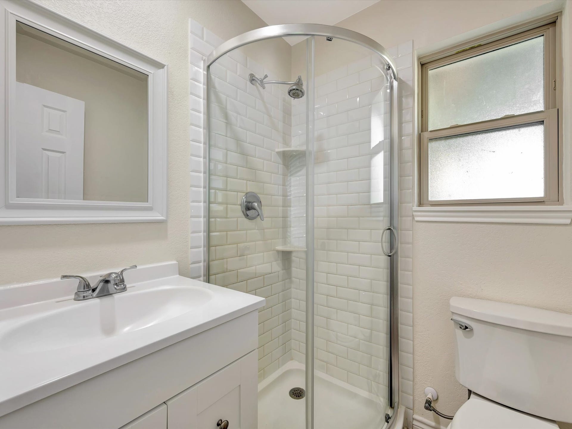 7230 Avenue L, Santa Fe, TX 77510 Primary suite bathroom featuring a glass-enclosed shower.